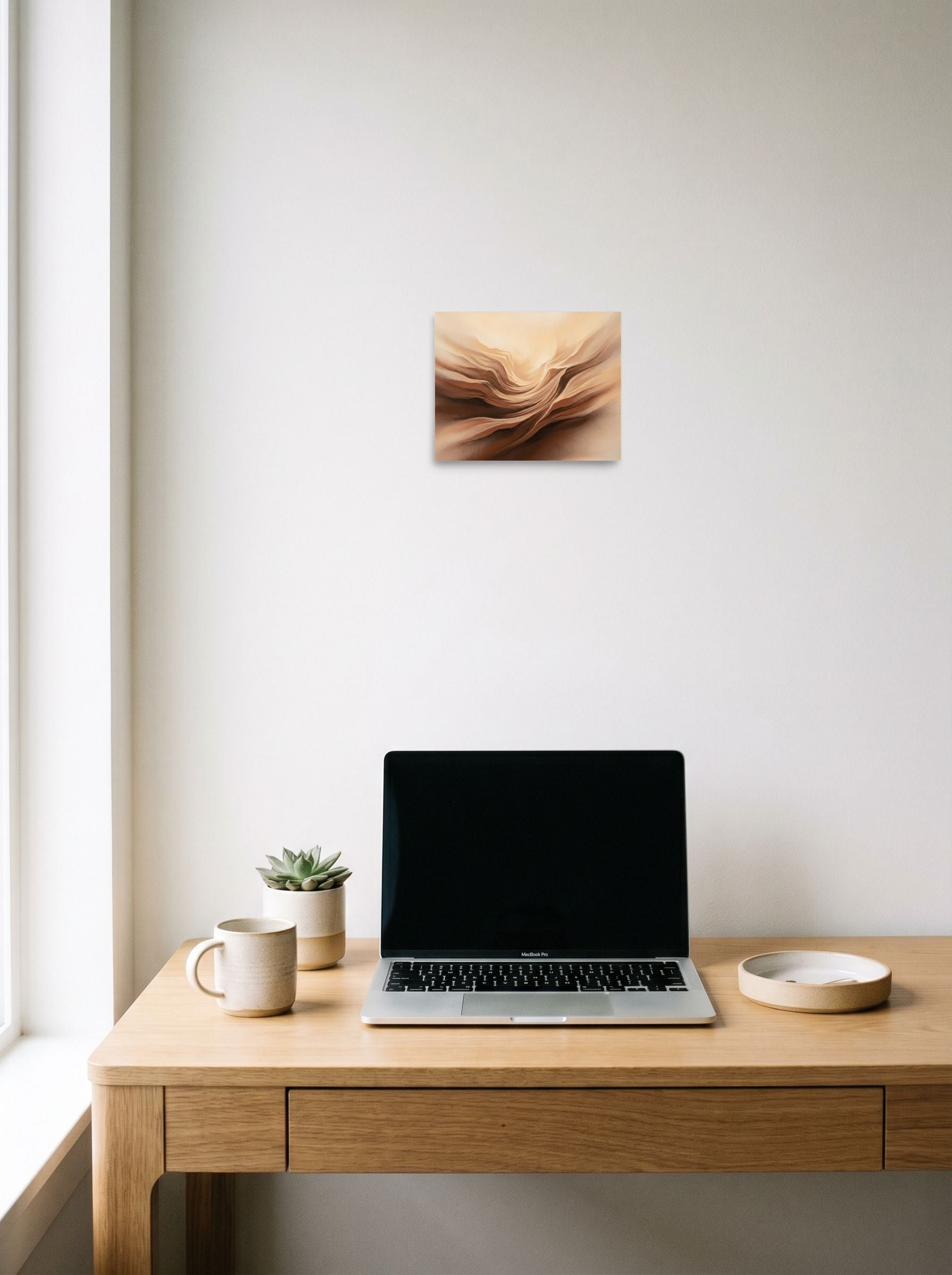 A 10x8 inch unframed paper Abstract art print of 'Earthly Folds' hanging above a worktable with a laptop.