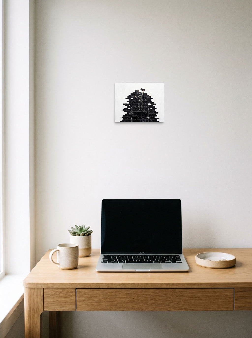 A 10x8 inch unframed paper Street art print of 'Brick by Brick', displayed over a compact desk setup.