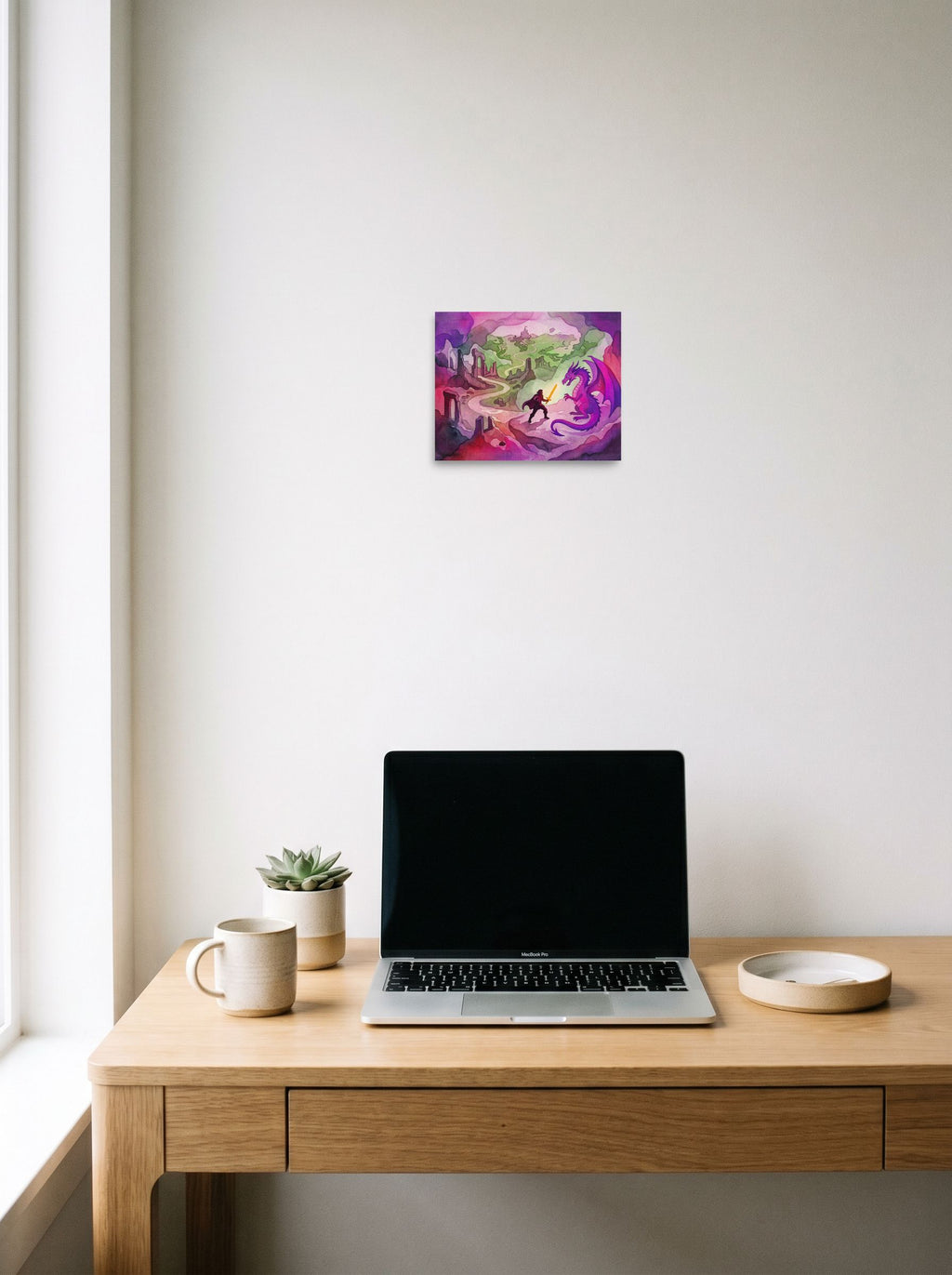 A 10x8 inch unframed paper Fantastic realism print of 'The Dragon's Challenge' hanging above a worktable with a laptop.