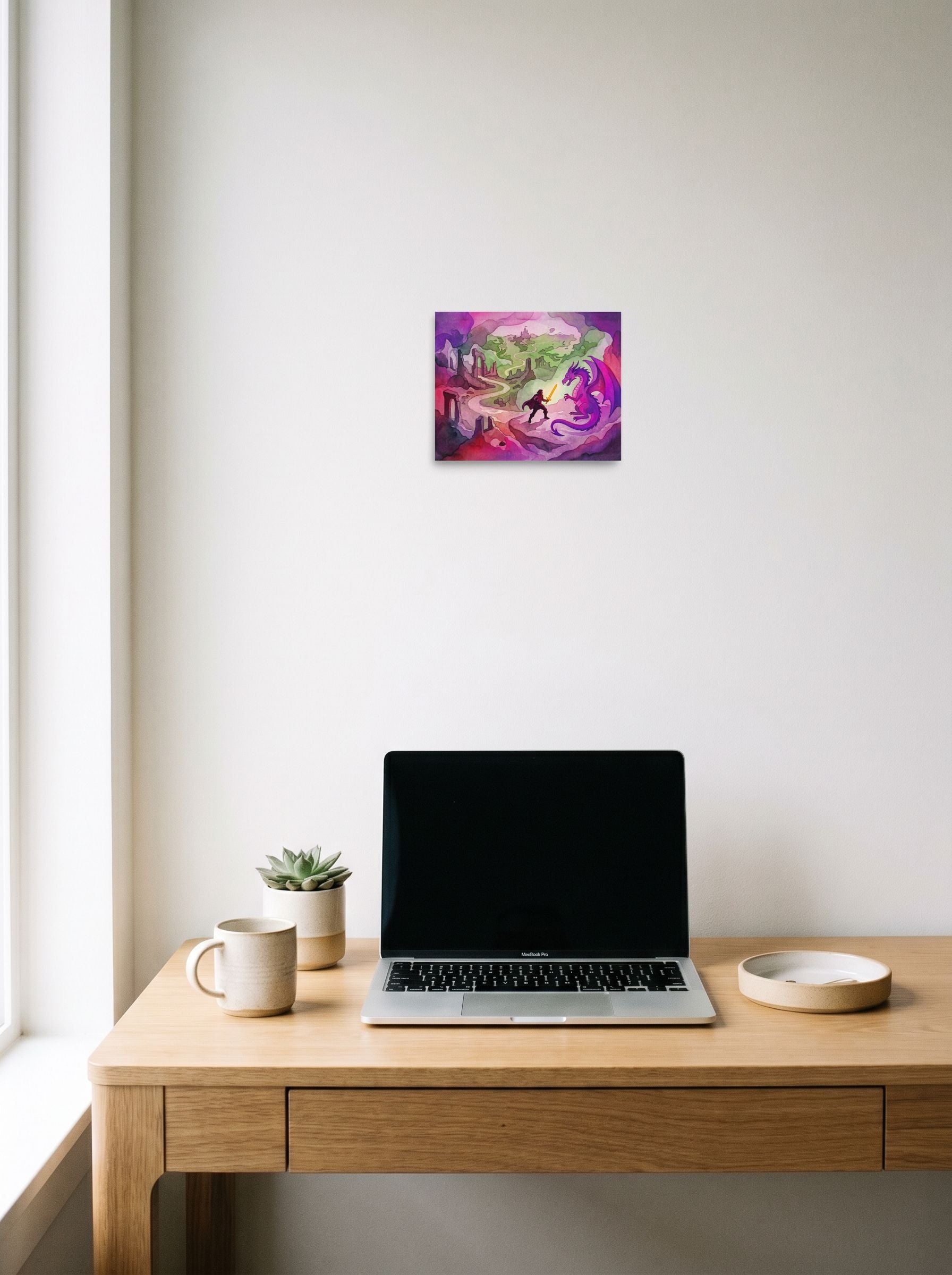 A 10x8 inch unframed paper Fantastic realism print of 'The Dragon's Challenge' hanging above a worktable with a laptop.