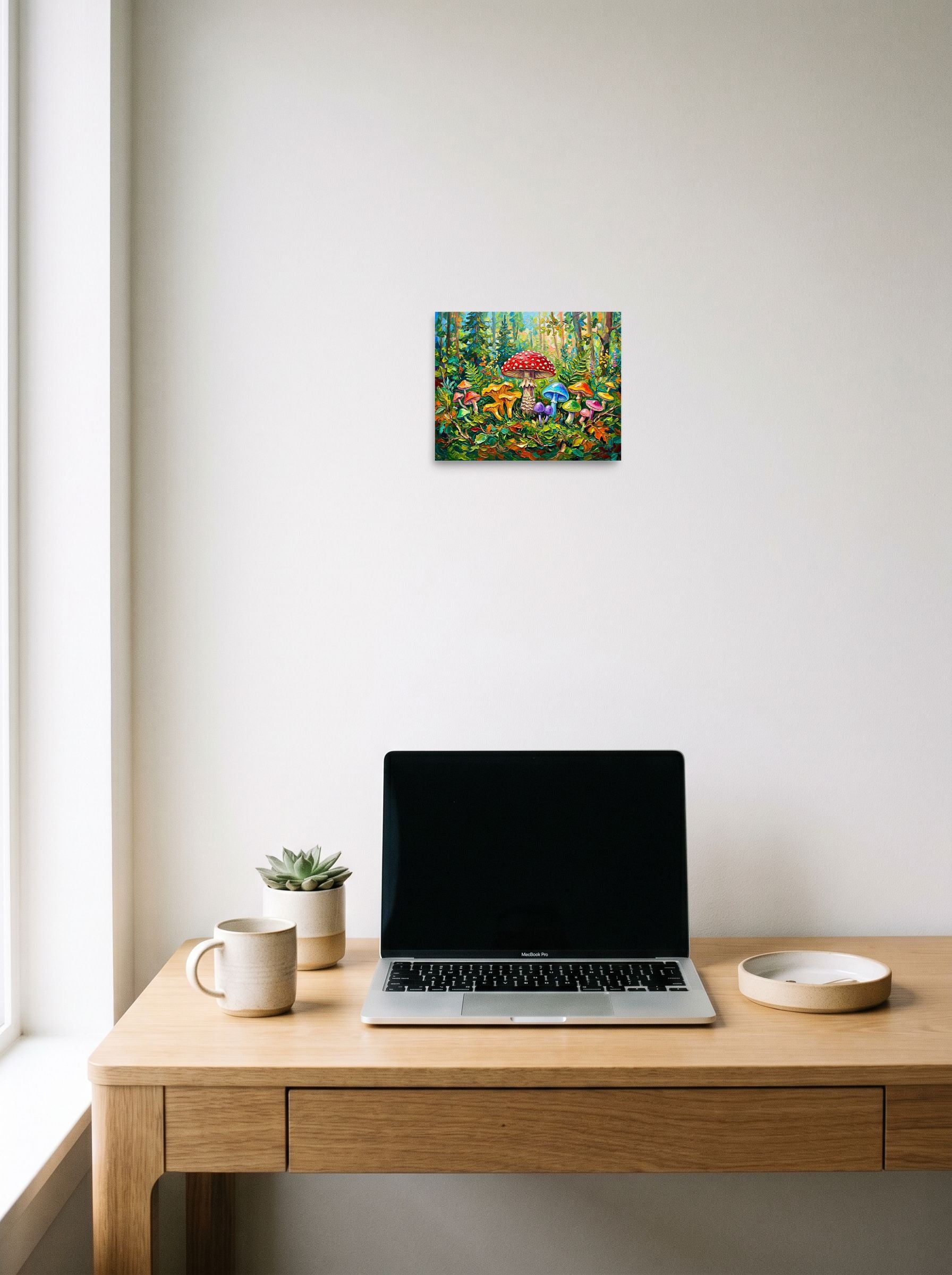 A 10x8 inch unframed paper Fauvism print of 'The Enchanted Grove' hanging above a worktable with a laptop.