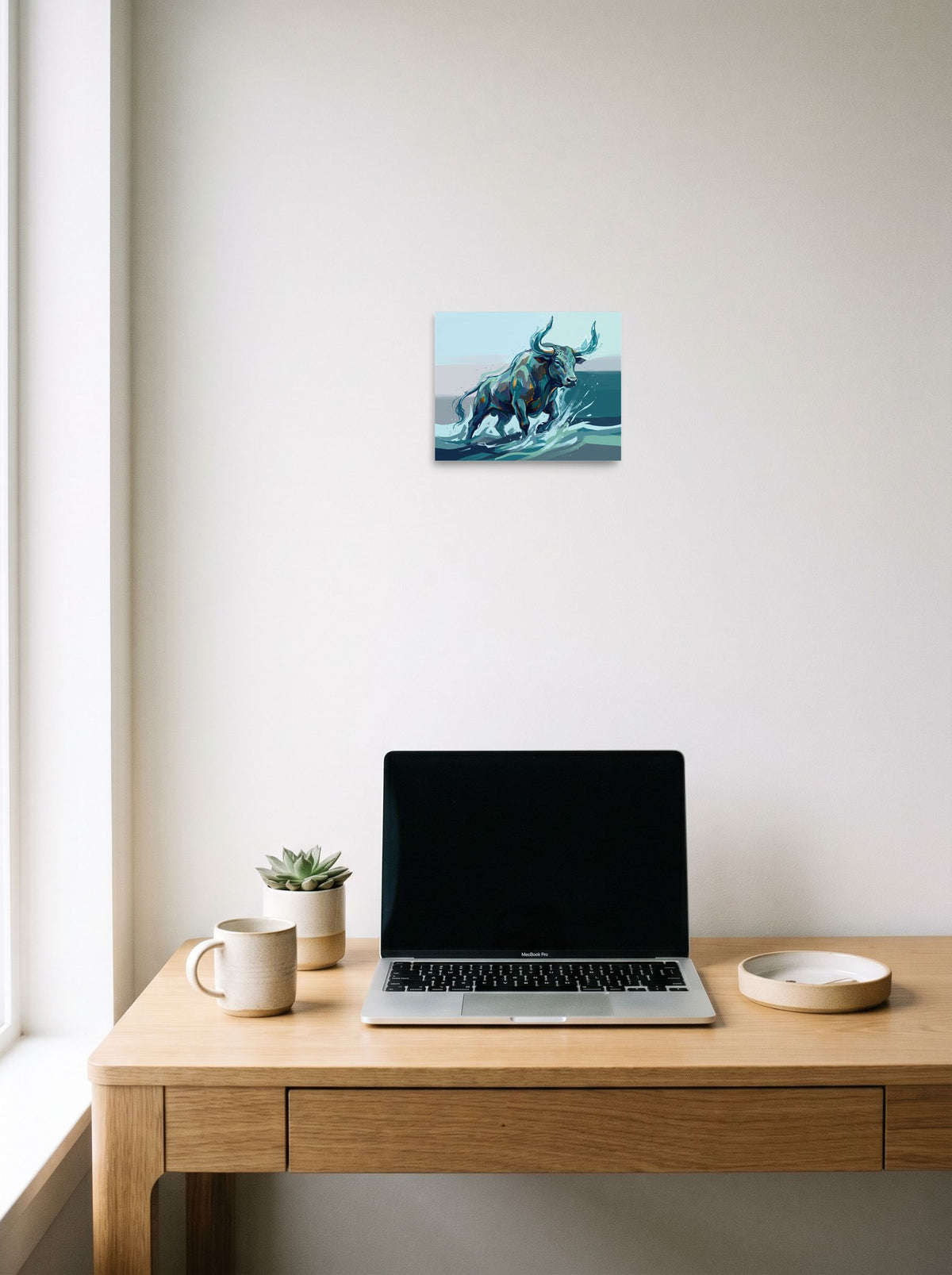 The Expressionism print 'The River Bull', 10x8 inch unframed paper, hanging above a worktable with a laptop.