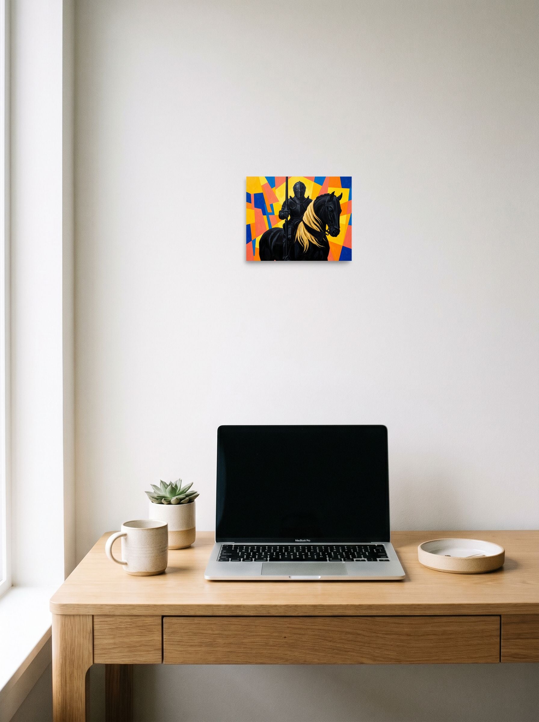 A 10x8 inch unframed paper Cubism,Figurative art print of 'The Abstract Knight' hanging above a worktable with a laptop.