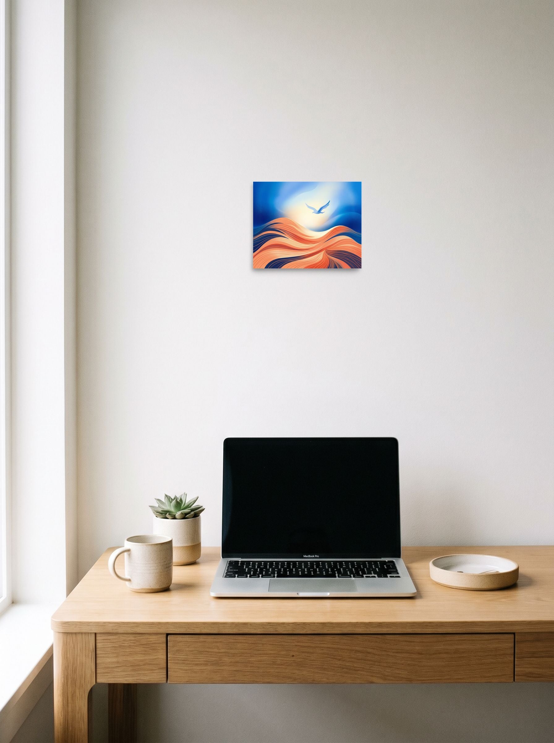 A 10x8 inch unframed paper Abstract art print of 'Flight Over the Dunes' hanging above a worktable with a laptop.