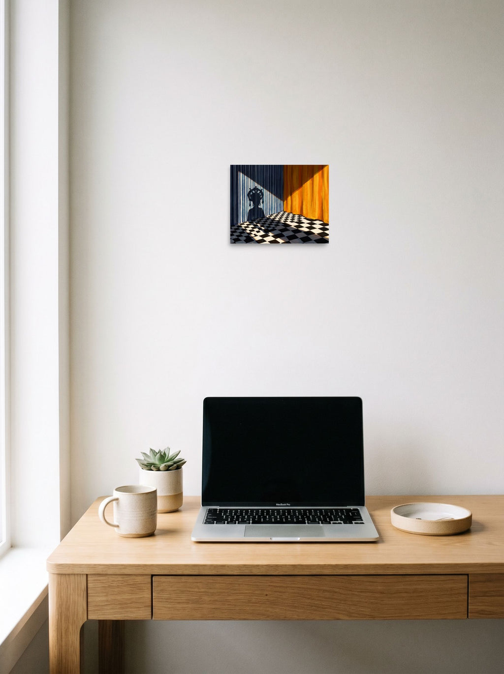 A 10x8 inch unframed paper Surrealism,Magic realism print of 'Crowned Silhouette' hanging above a worktable with a laptop.
