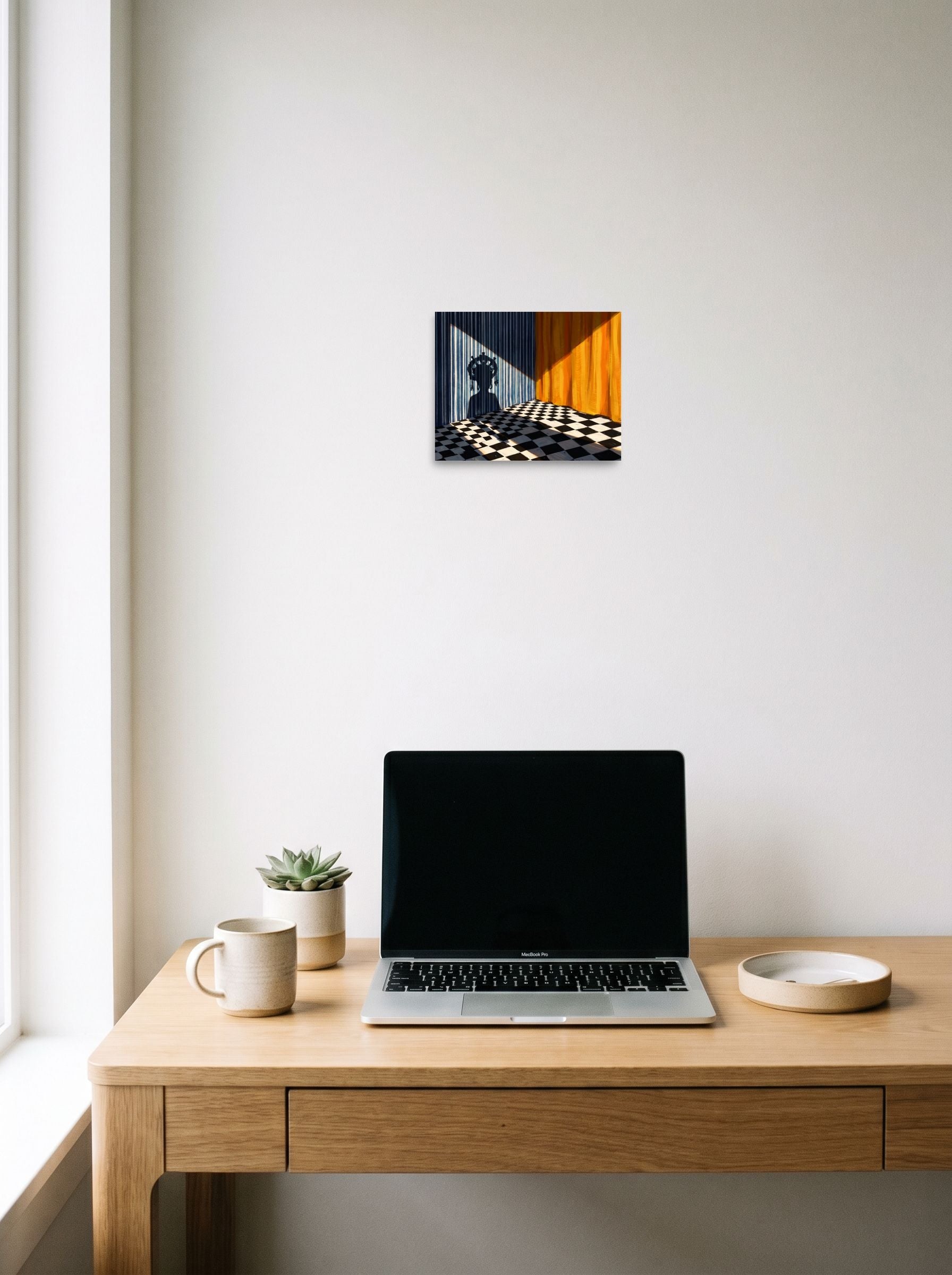 A 10x8 inch unframed paper Surrealism,Magic realism print of 'Crowned Silhouette' hanging above a worktable with a laptop.