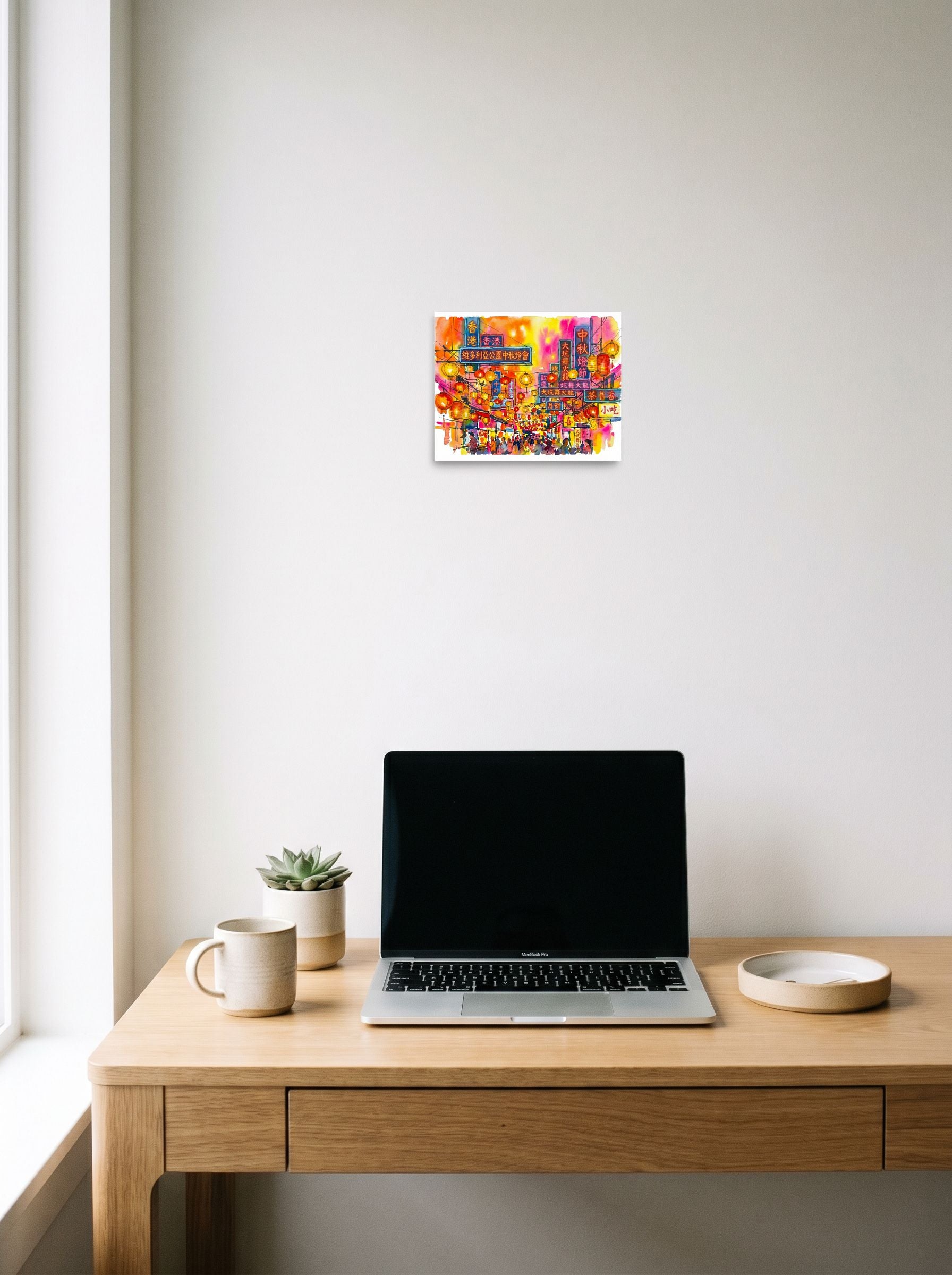 A 10x8 inch unframed paper Fauvism print of 'Lantern Festival Glow' hanging above a worktable with a laptop.