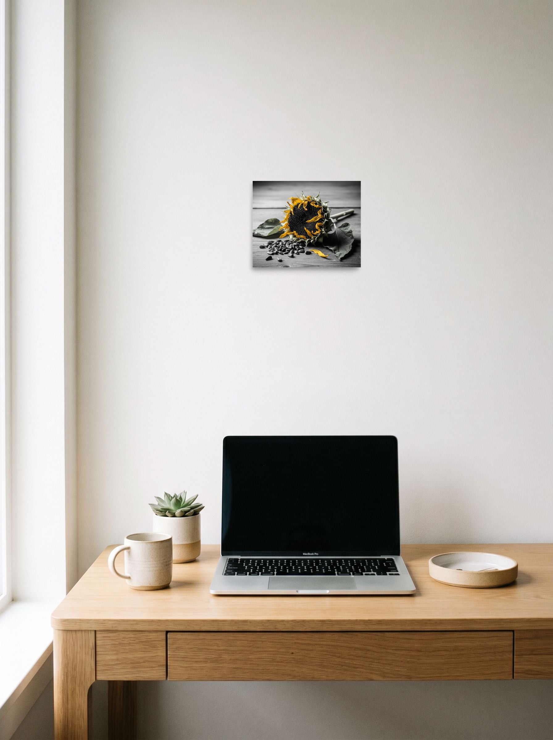 A 10x8 inch unframed paper Art photography print of 'Harvest Echoes' hanging above a worktable with a laptop.
