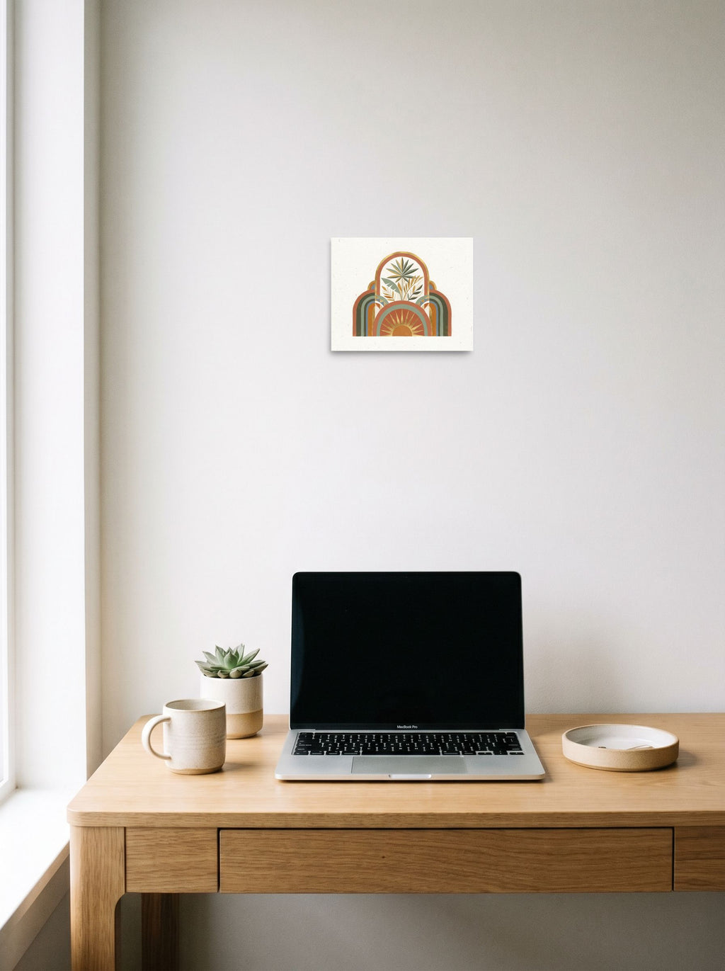 A 10x8 inch unframed paper Minimalism,Geometric abstract art print of 'Golden Archway Oasis' hanging above a worktable with a laptop.