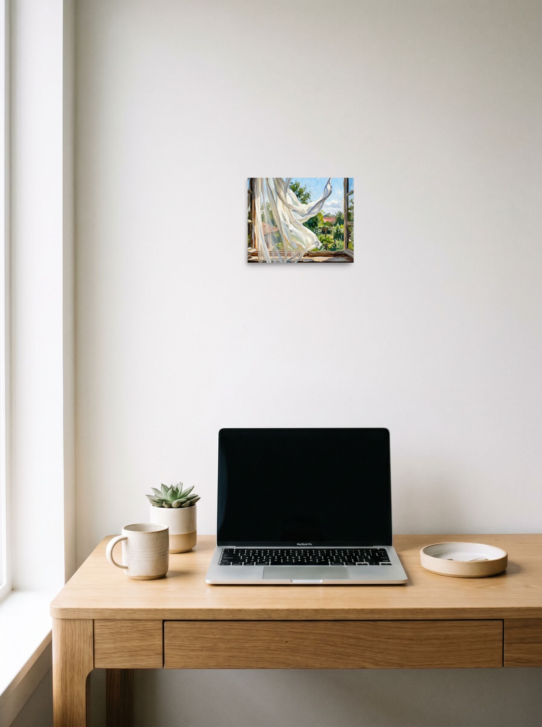 A 10x8 inch unframed paper Impressionism,Plein Air print of 'The Open Window' hanging above a worktable with a laptop.