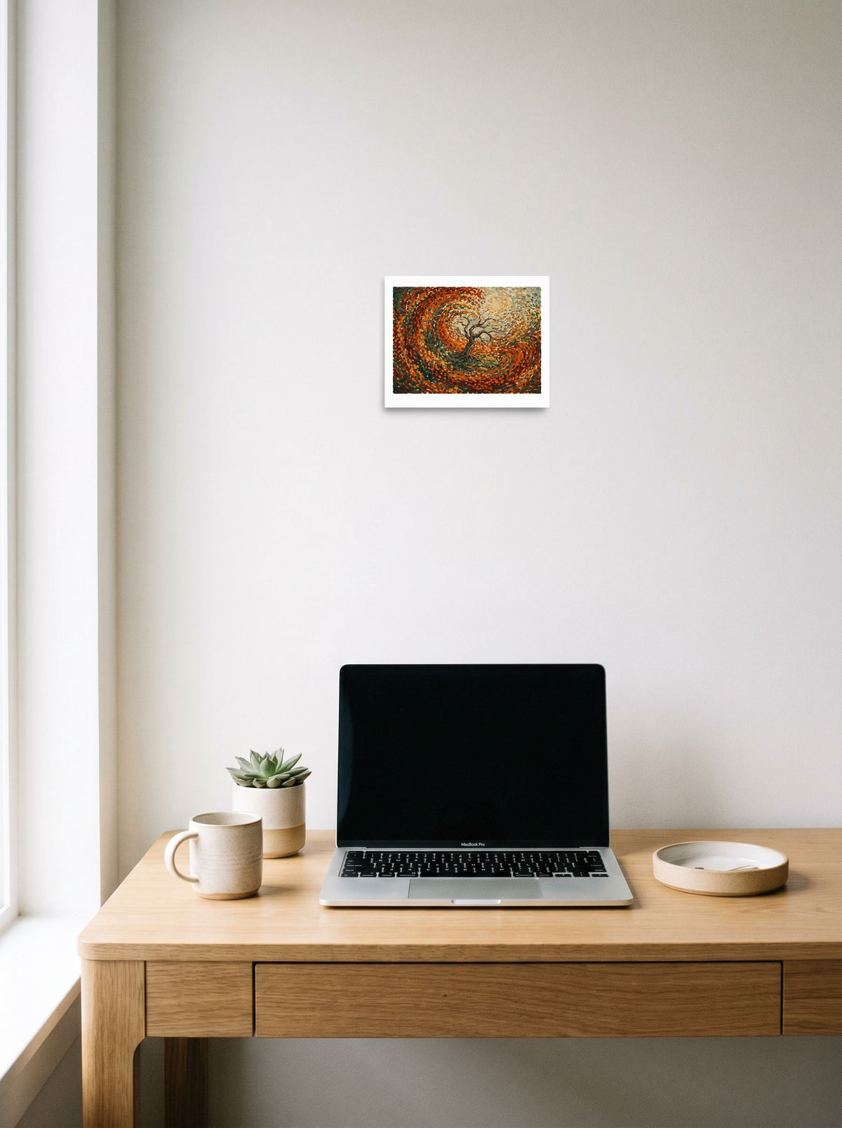 'Autumn's Embrace', a Post-Impressionism print hanging above a worktable with a laptop. Shown as unframed paper, 10x8 inch.