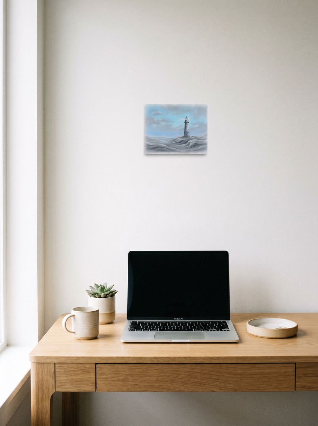A 10x8 inch unframed paper Realism print of 'The Silent Beacon' hanging above a worktable with a laptop.