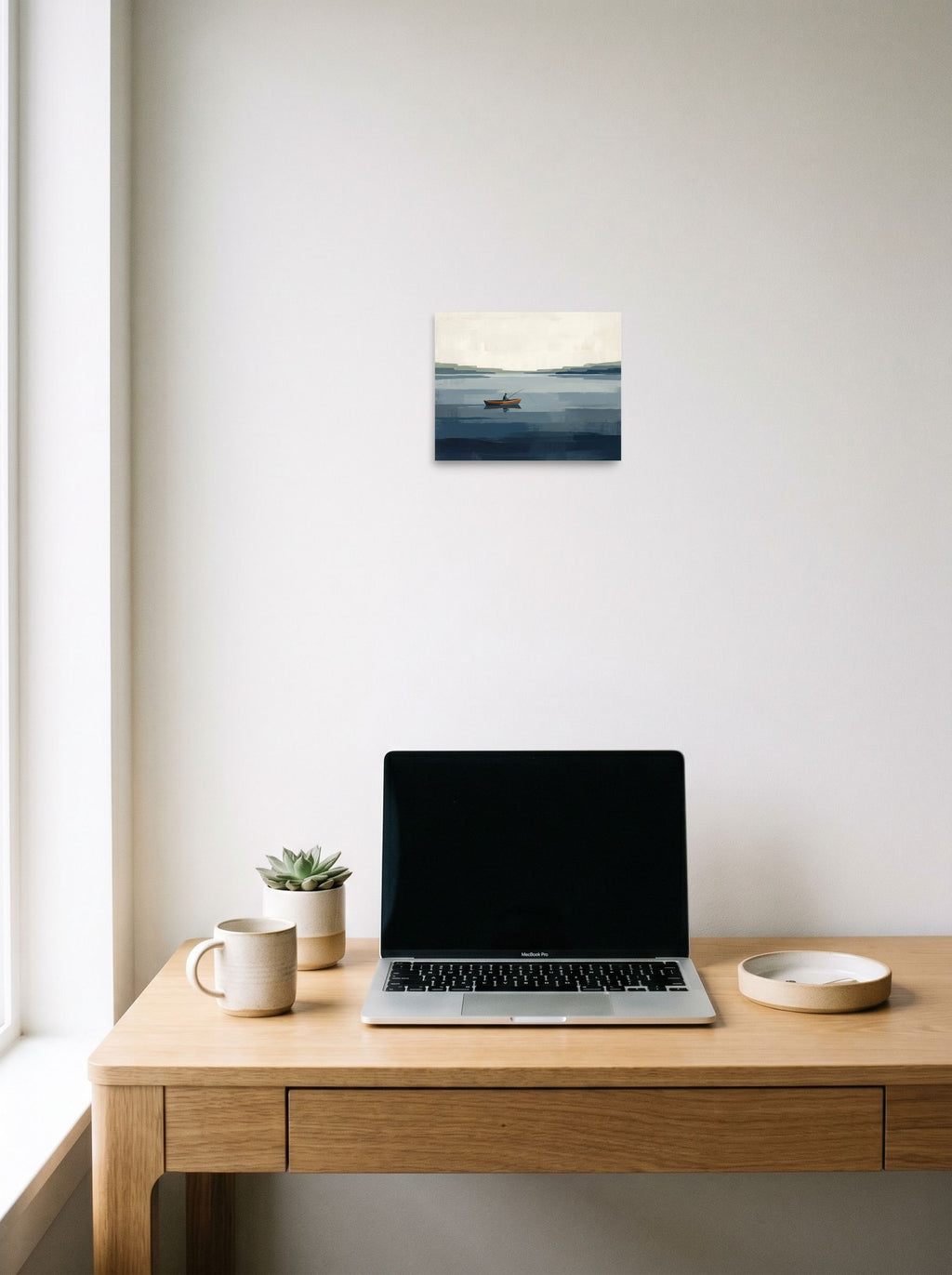 A 10x8 inch unframed paper Minimalism print of 'Quiet Waters' hanging above a worktable with a laptop.