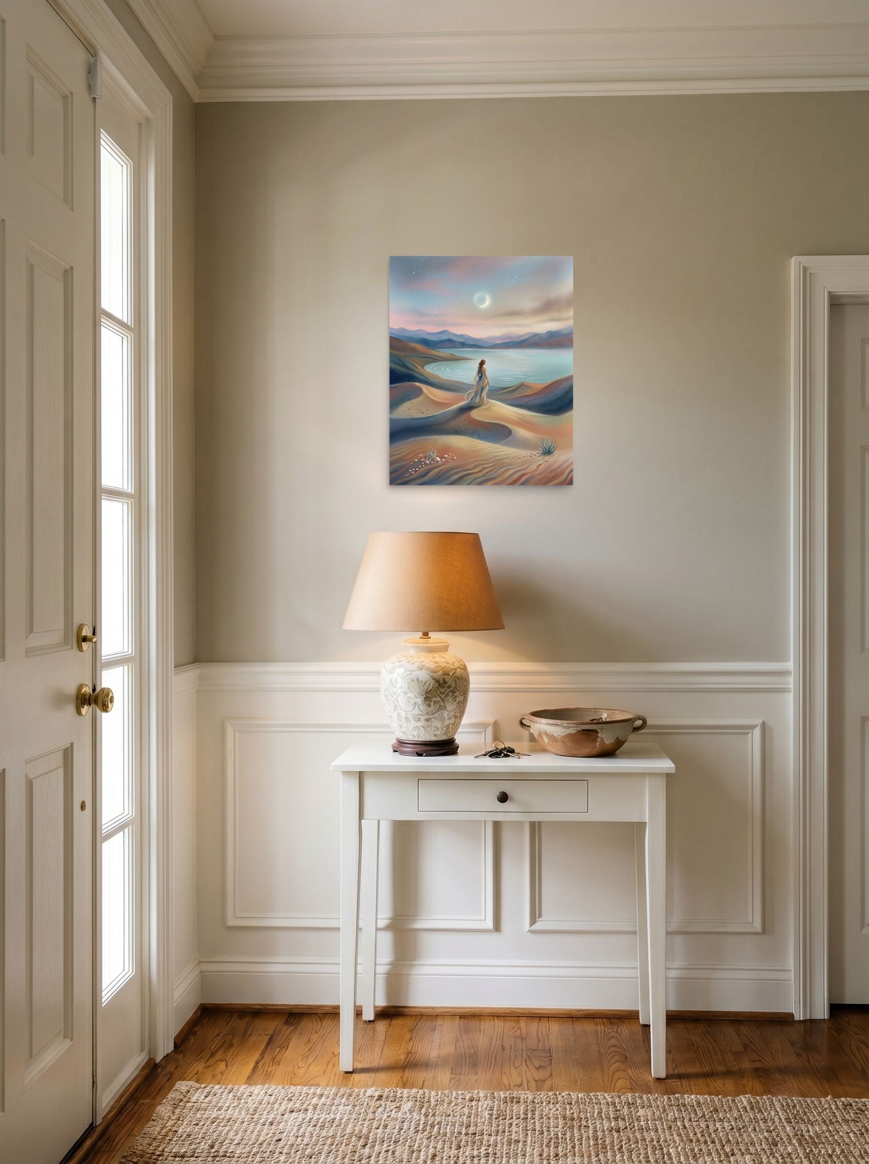 A 16x20 inch unframed paper Magic realism print of 'Desert Moonrise' hanging in an entryway near a console.