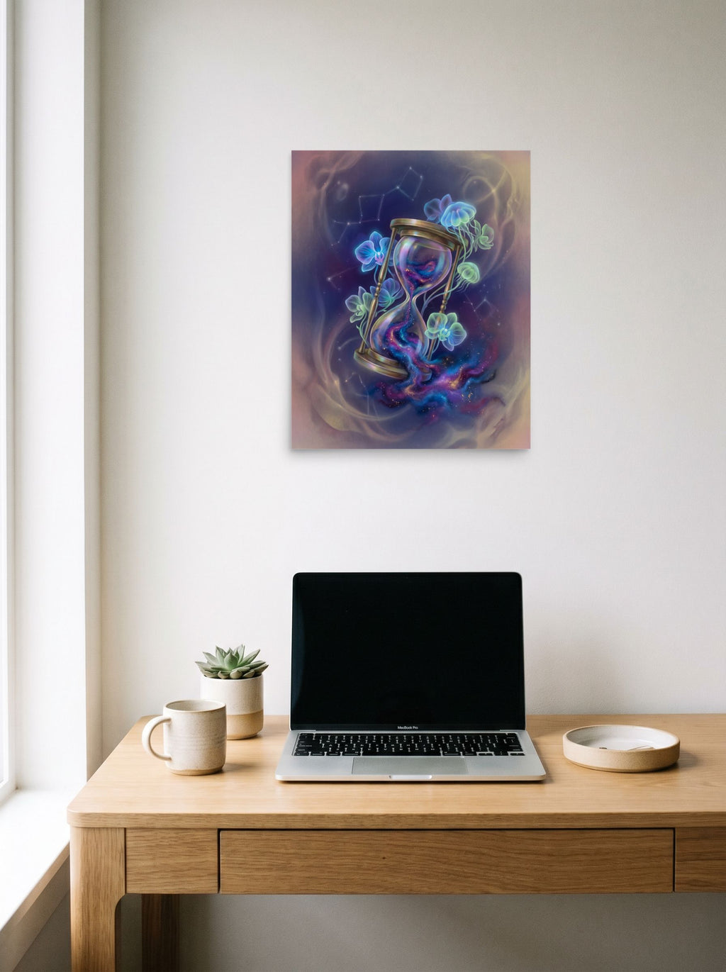 A 16x20 inch unframed paper Magic realism print of 'Sands of the Nebula' hanging above a worktable with a laptop.