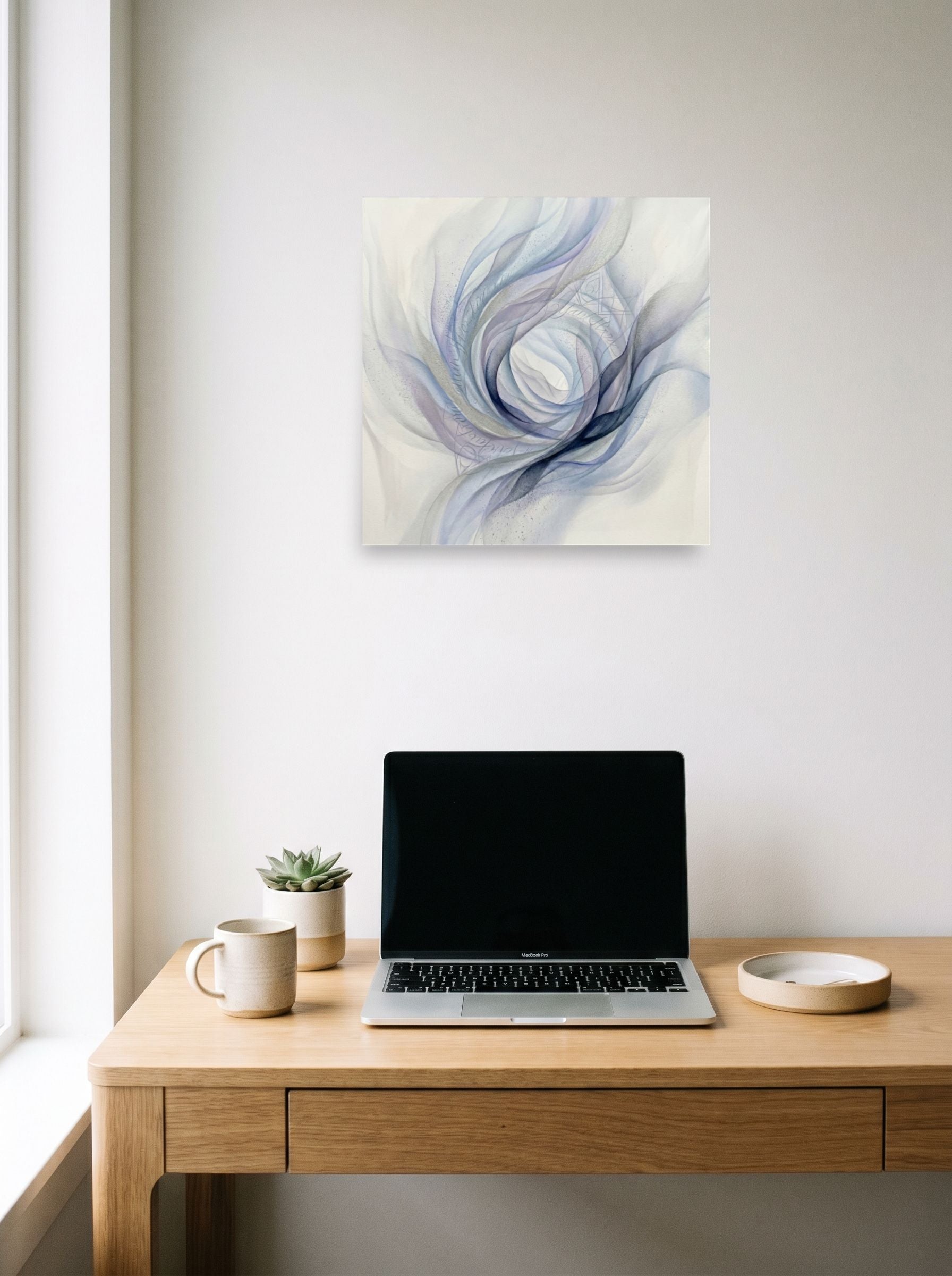 A 18x18 inch unframed paper Abstract art print of 'Ethereal Whispers in the Vortex' hanging above a worktable with a laptop.