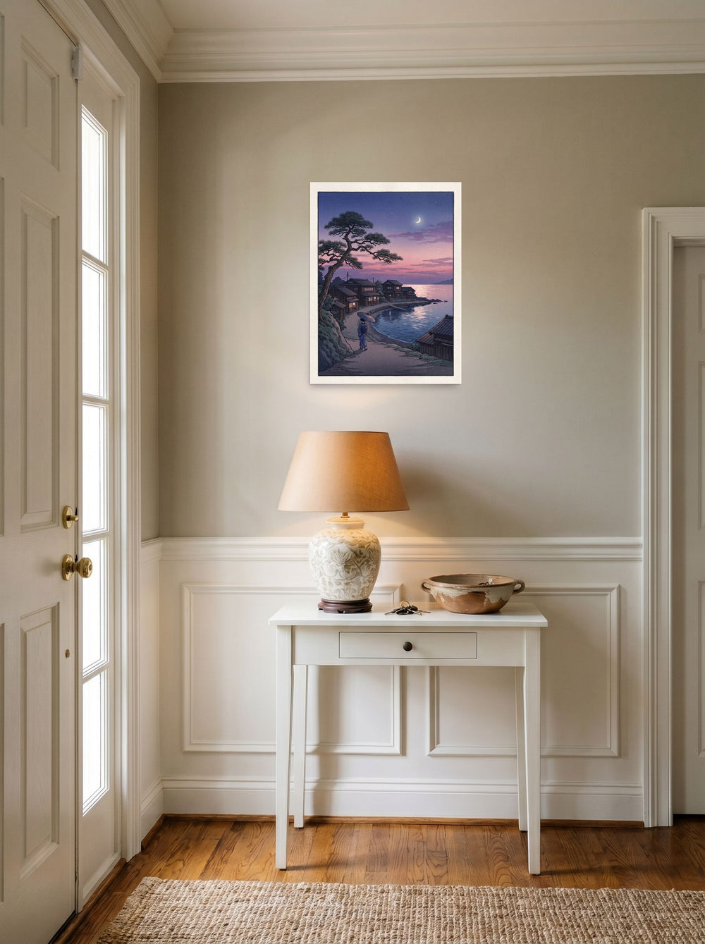 A 18x24 inch unframed paper Shin hanga print of 'Crescent Moon Bay' hanging in an entryway near a console.