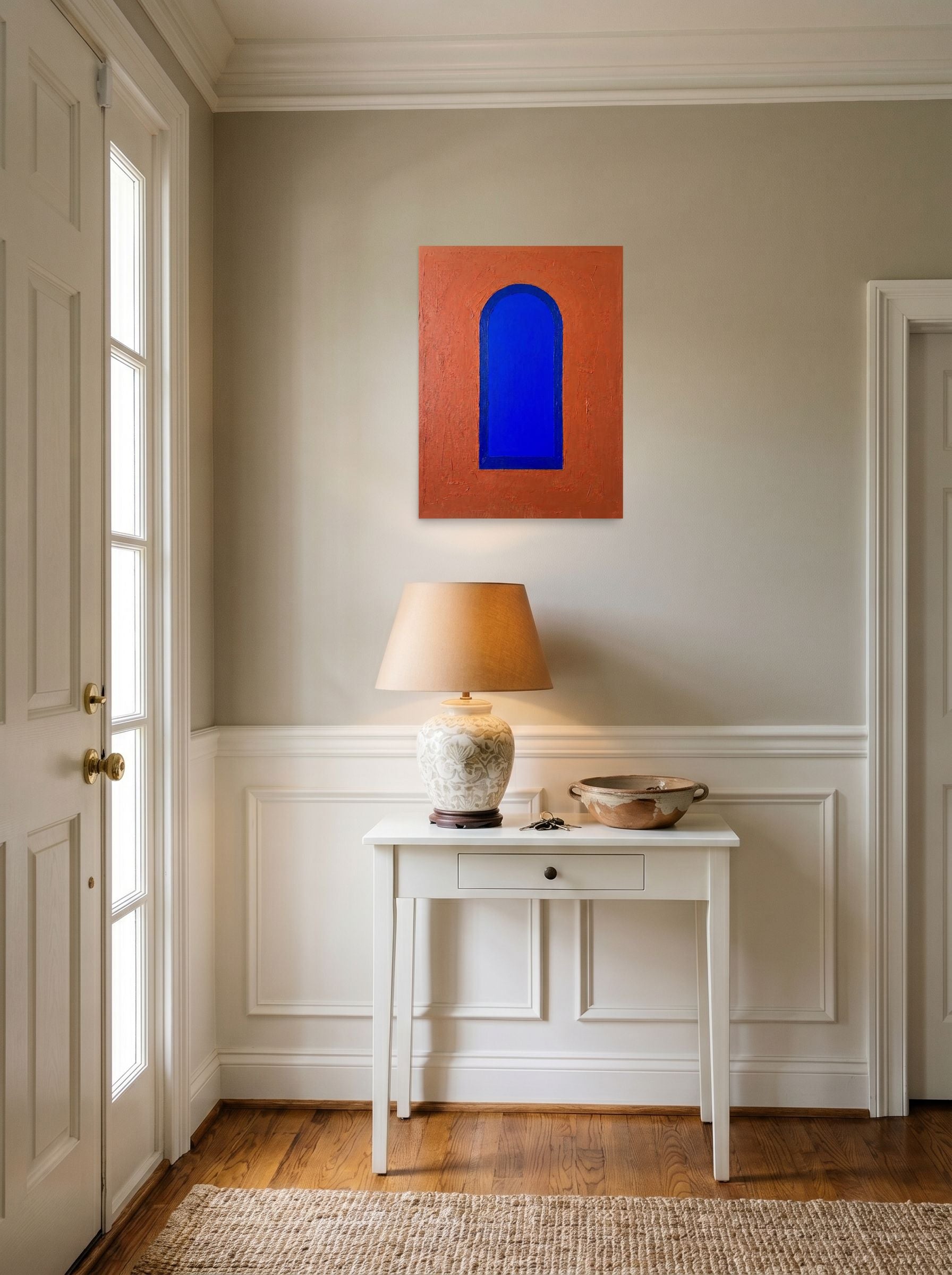 A 18x24 inch unframed paper Minimalism print of 'The Blue Arch' hanging in an entryway near a console.