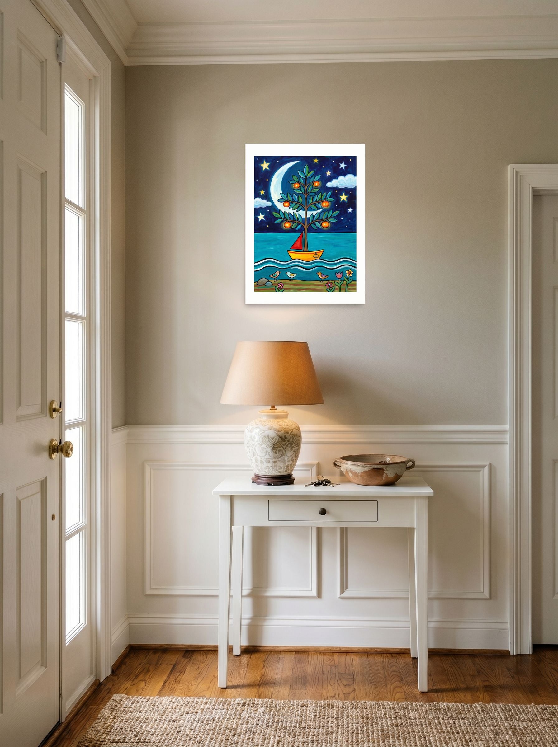 A 18x24 inch unframed paper Naive art print of 'The Glowing Orchard Boat' hanging in an entryway near a console.
