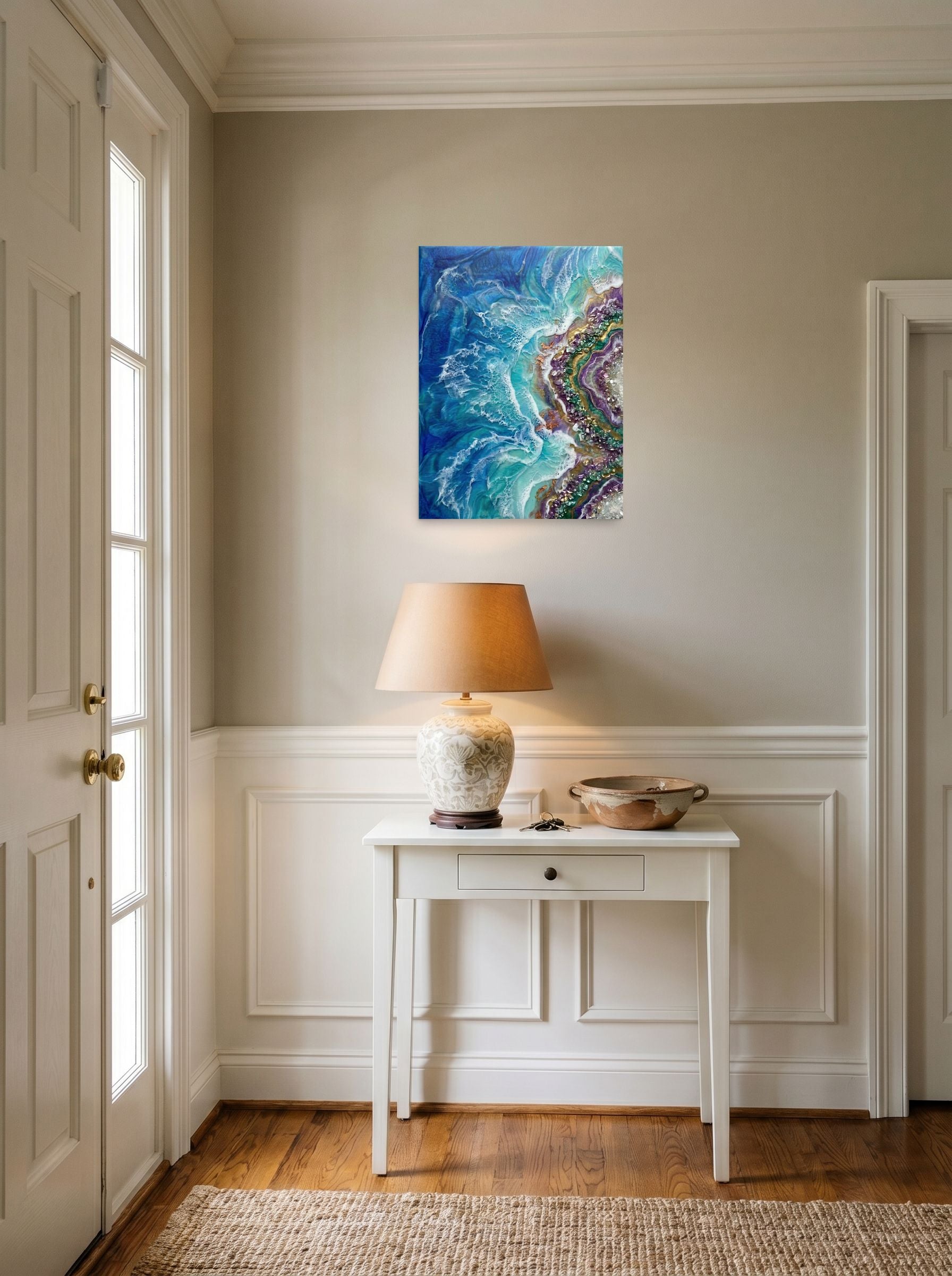 A 18x24 inch unframed paper Abstract art print of 'Crystal Coast' hanging in an entryway near a console.
