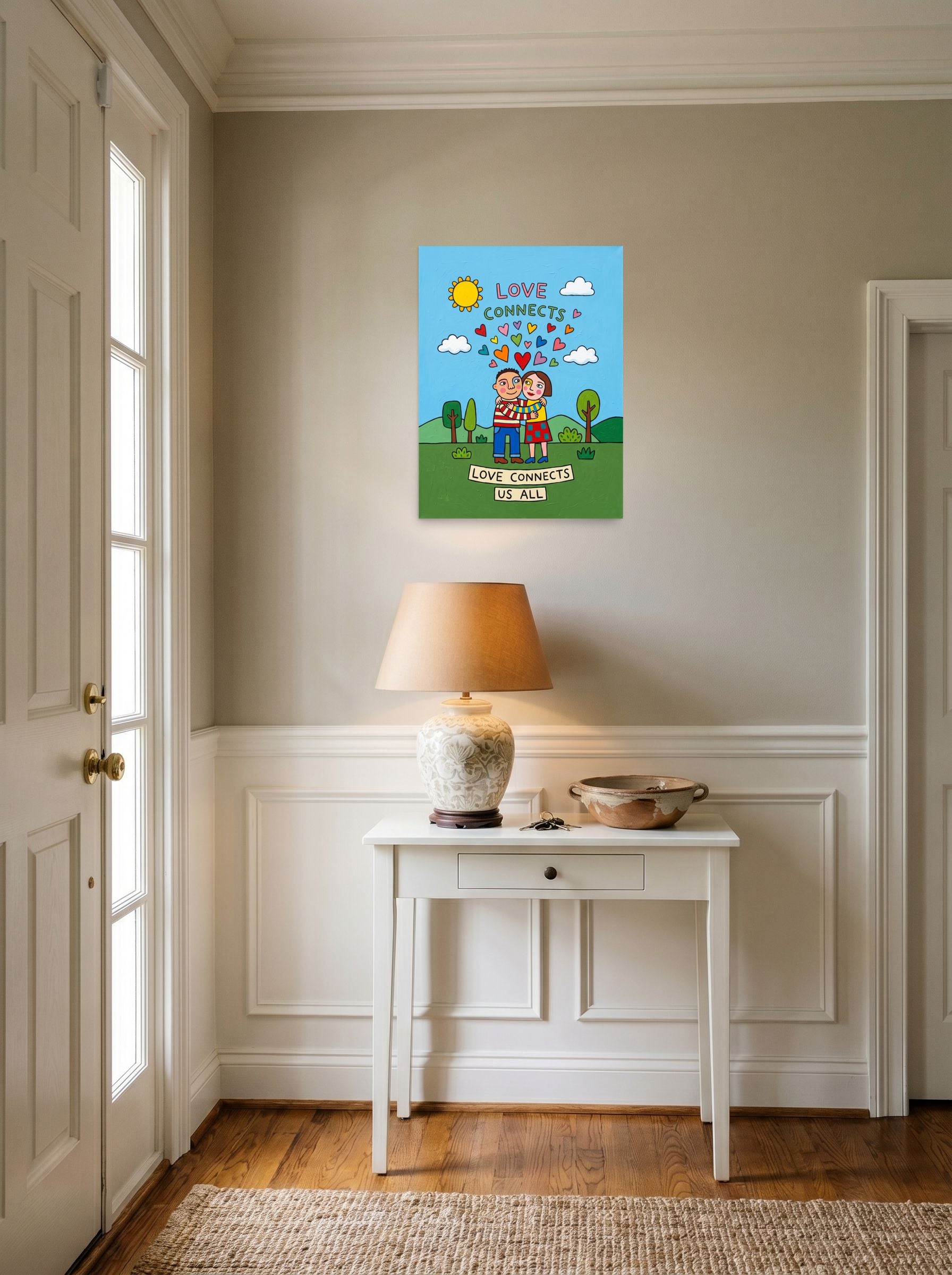 A 18x24 inch unframed paper Naive art print of 'Love Connects Us All' hanging in an entryway near a console.