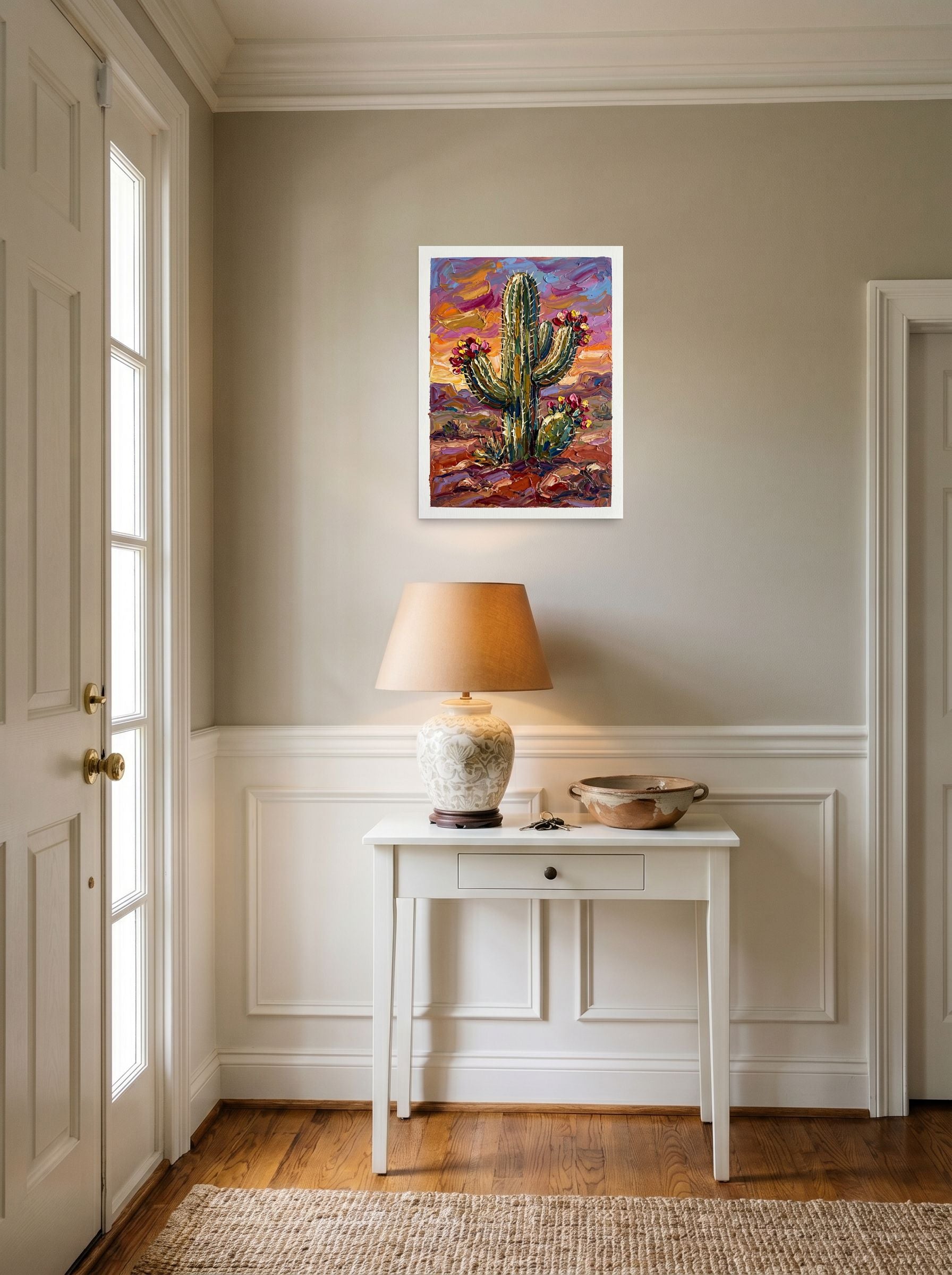 A 18x24 inch unframed paper Expressionism print of 'Desert Bloom' hanging in an entryway near a console.