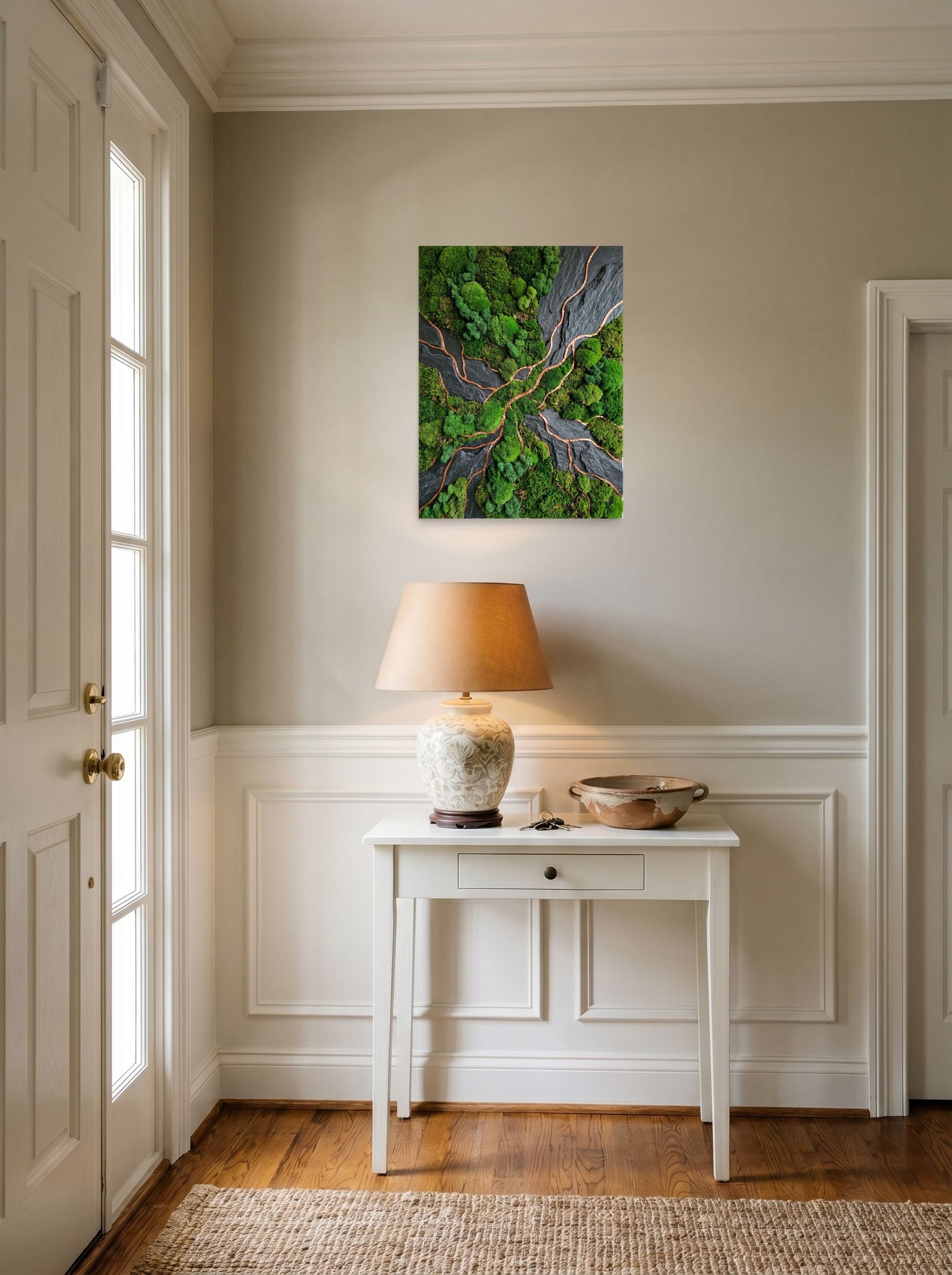 A 18x24 inch unframed paper Environmental art,Assemblage print of 'Moss and Slate' hanging in an entryway near a console.