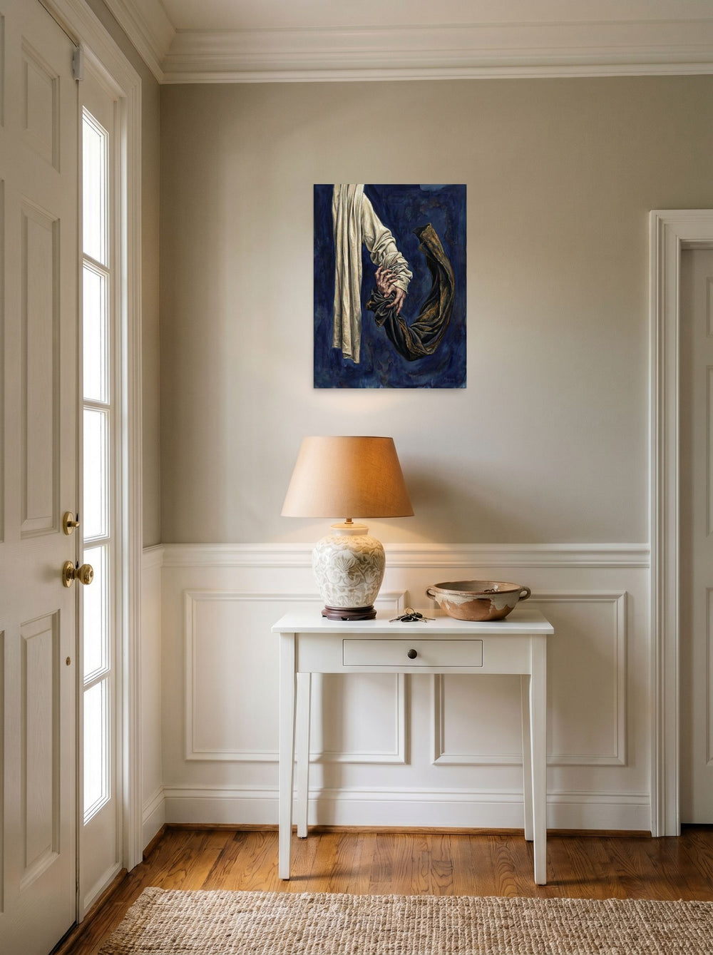 A 18x24 inch unframed paper Realism,Surrealism print of 'Tethered Grasp' hanging in an entryway near a console.