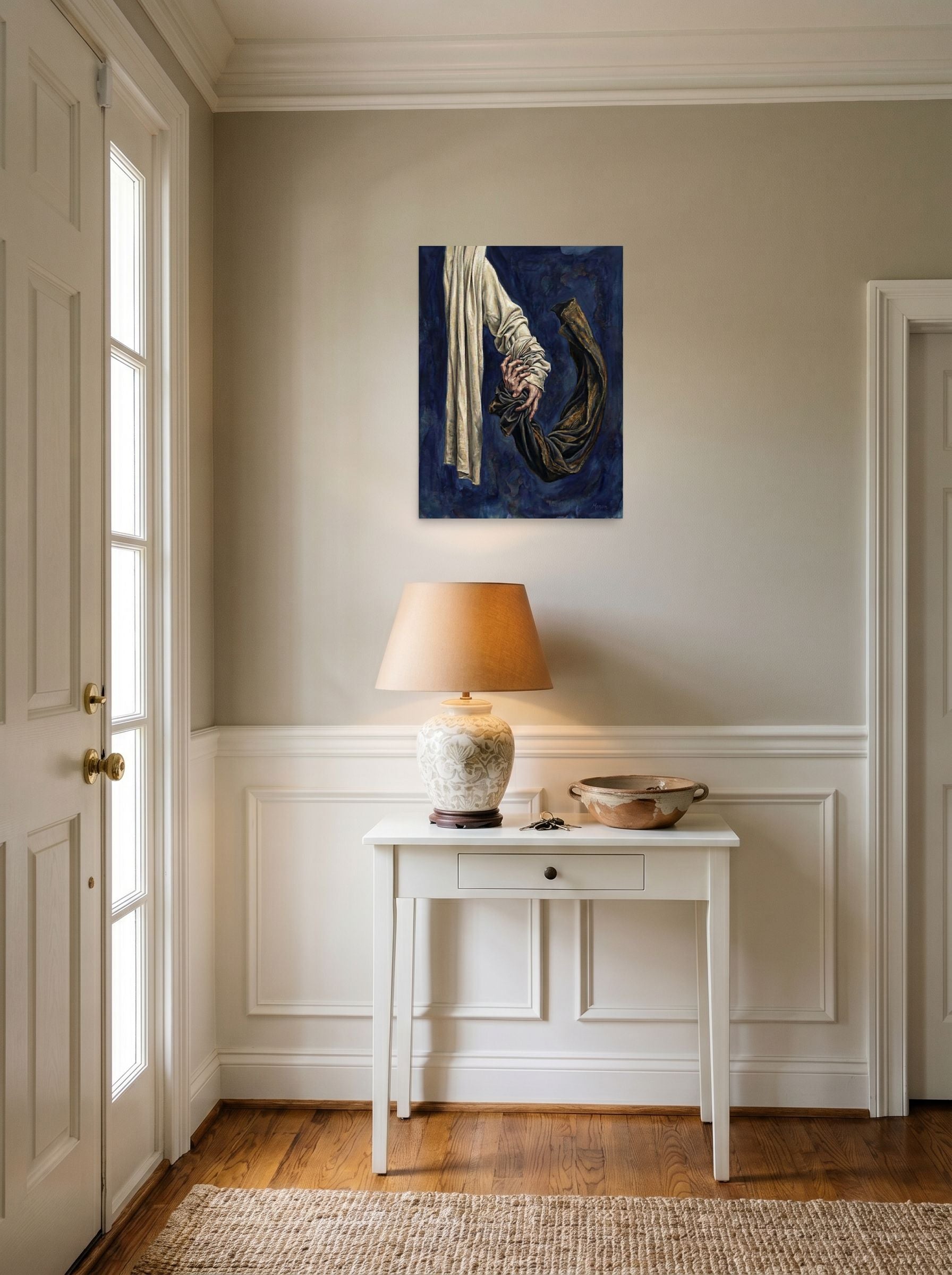 A 18x24 inch unframed paper Realism,Surrealism print of 'Tethered Grasp' hanging in an entryway near a console.