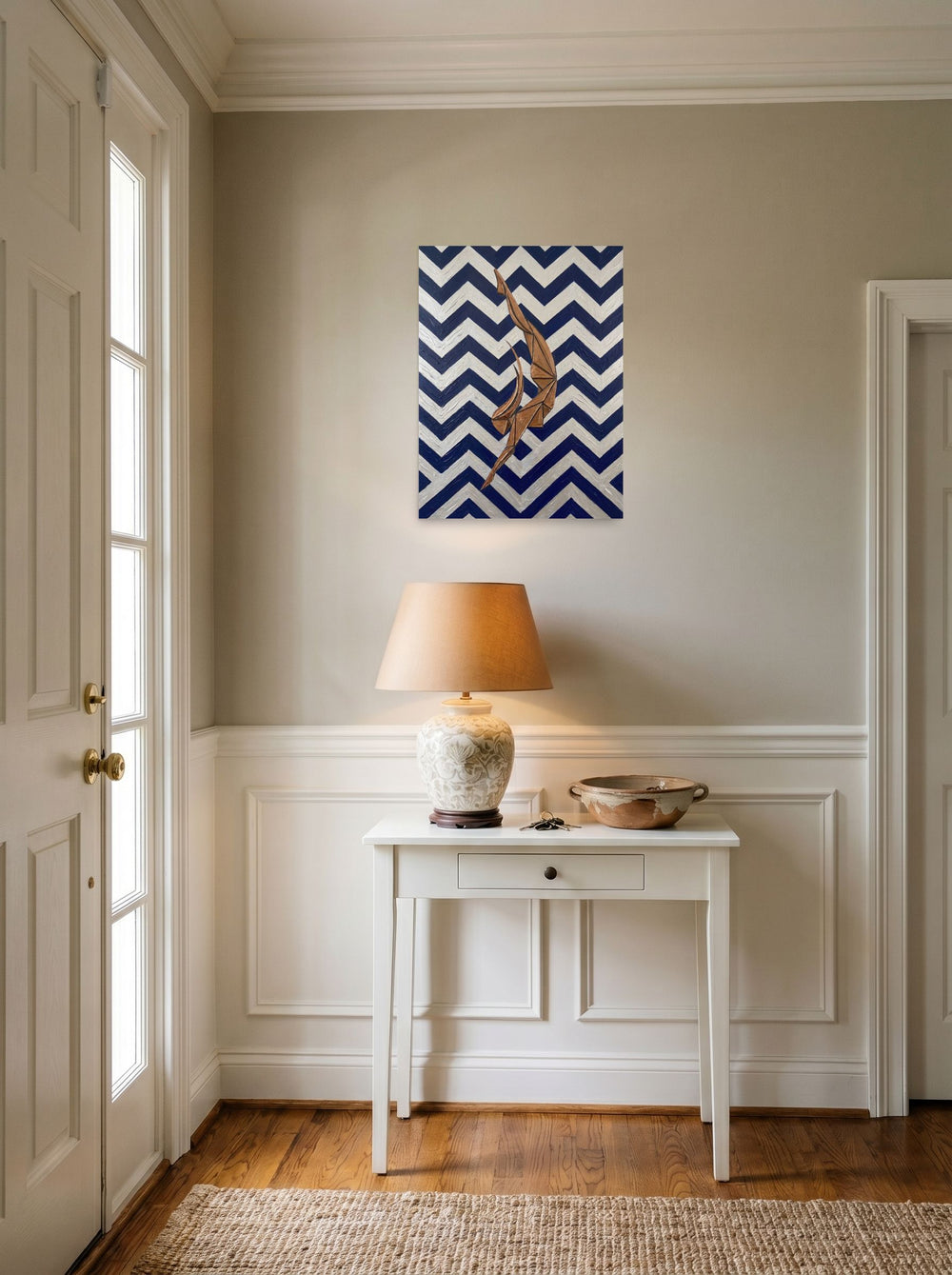 A 18x24 inch unframed paper Art Deco print of 'The Deco Diver' hanging in an entryway near a console.