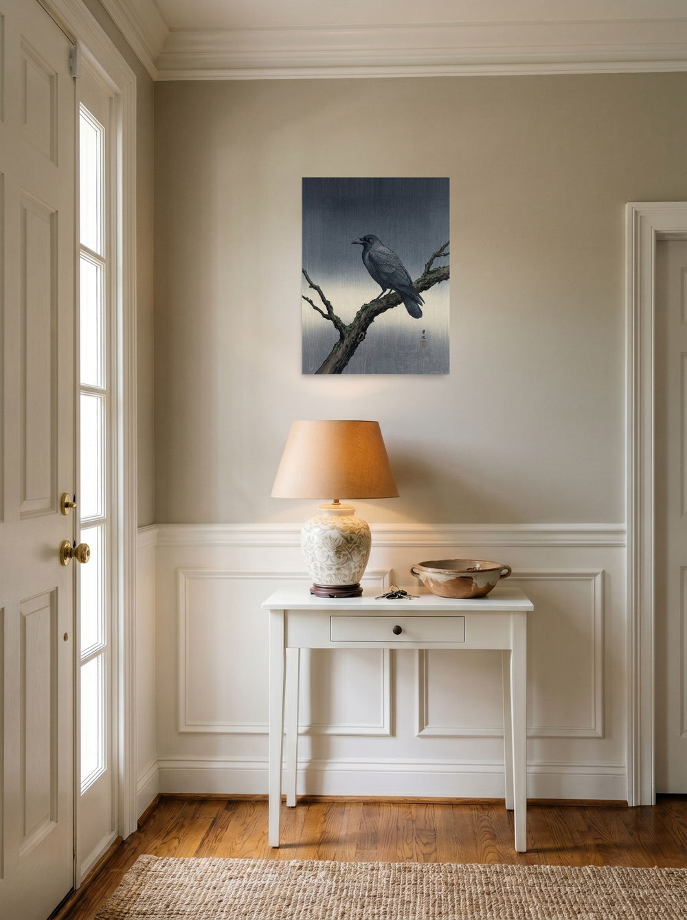 A 18x24 inch unframed paper Shin hanga print of 'Solitary Raven at Dusk' hanging in an entryway near a console.