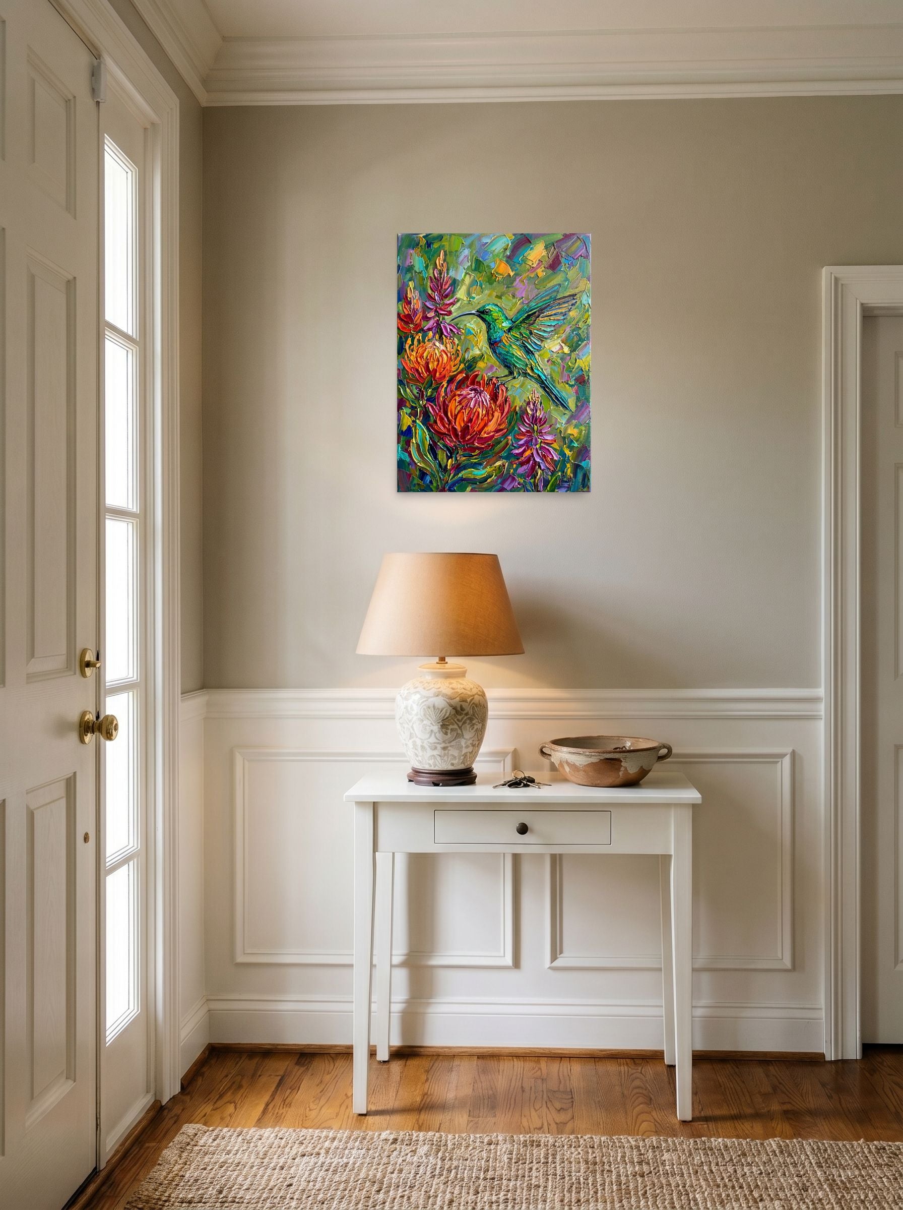 A 18x24 inch unframed paper Impressionism print of 'Emerald Flight Among Proteas' hanging in an entryway near a console.