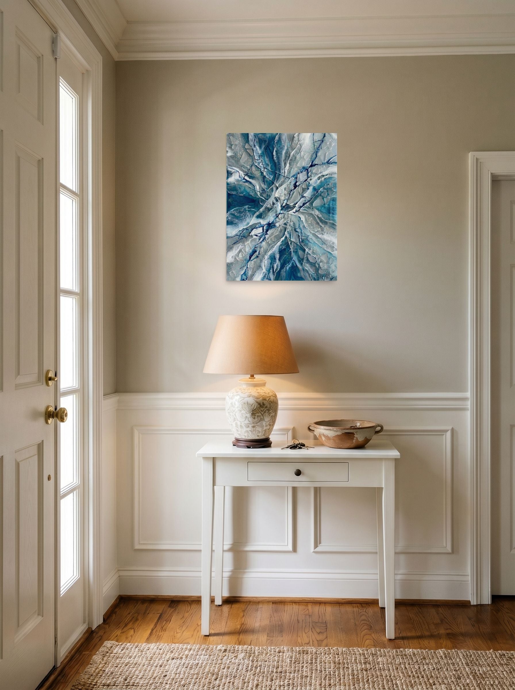 A 18x24 inch unframed paper Abstract art print of 'Shattered Frost' hanging in an entryway near a console.