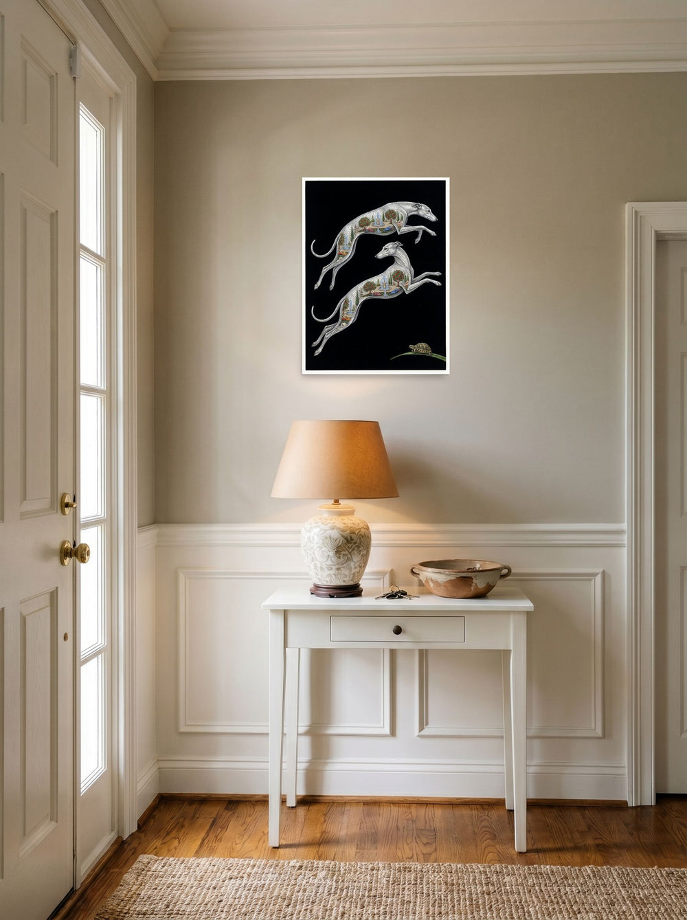A 18x24 inch unframed paper Art Deco print of 'Greyhound Gardens' hanging in an entryway near a console.