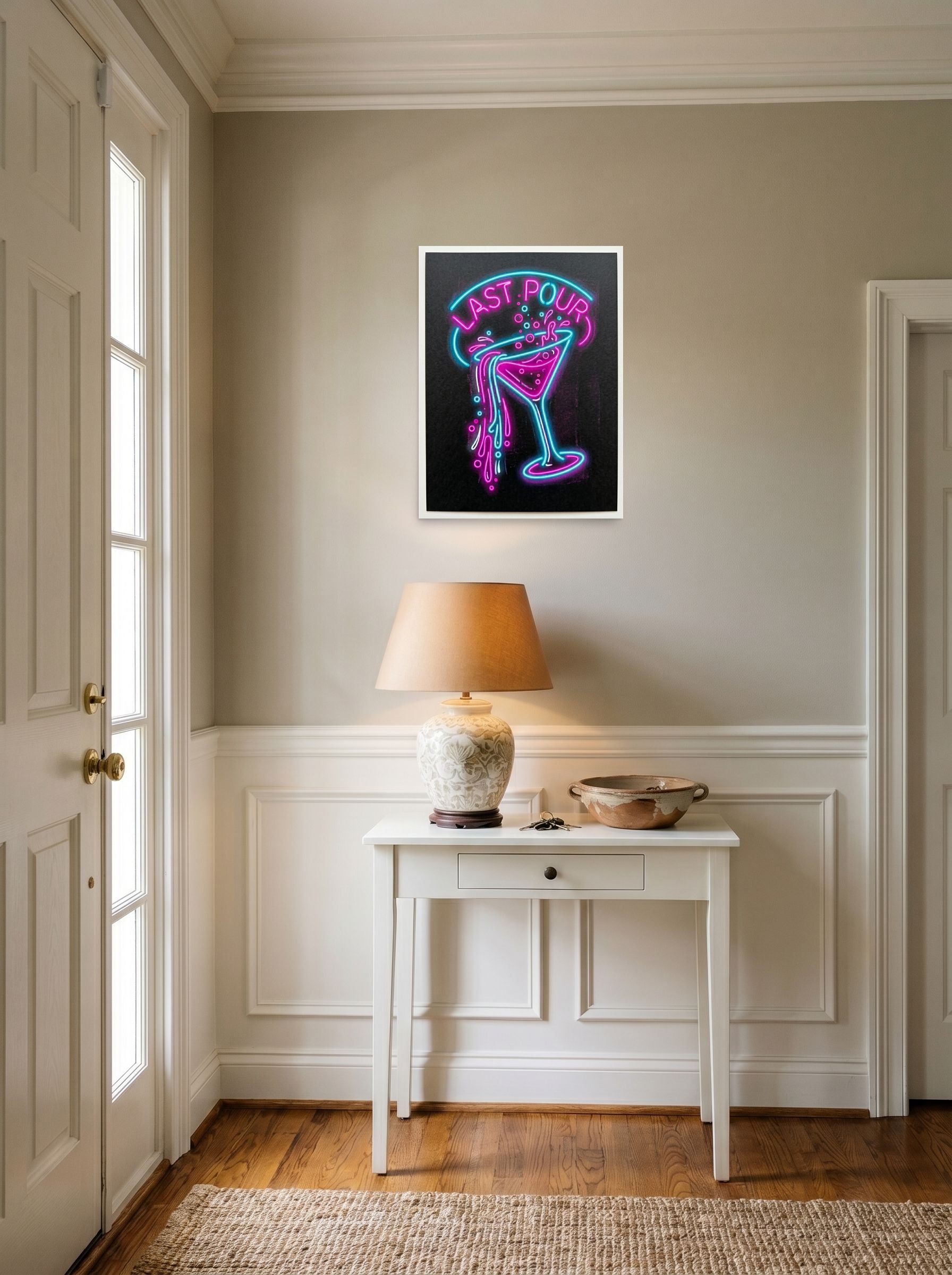 A 18x24 inch unframed paper Pop art print of 'Last Pour' hanging in an entryway near a console.