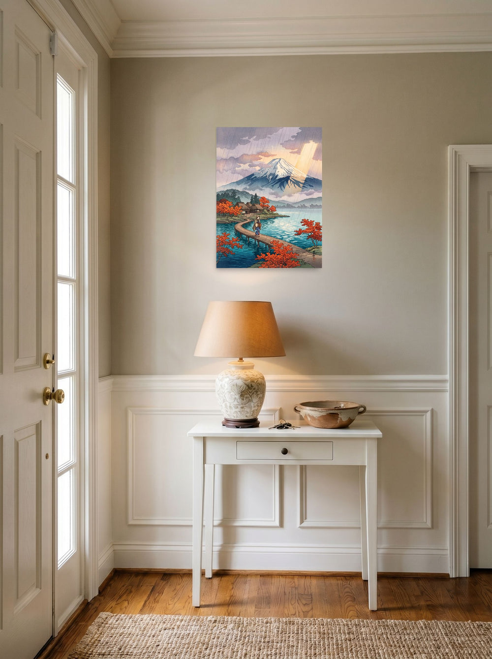 A 18x24 inch unframed paper Shin hanga print of 'Sunshower Over Fuji' hanging in an entryway near a console.