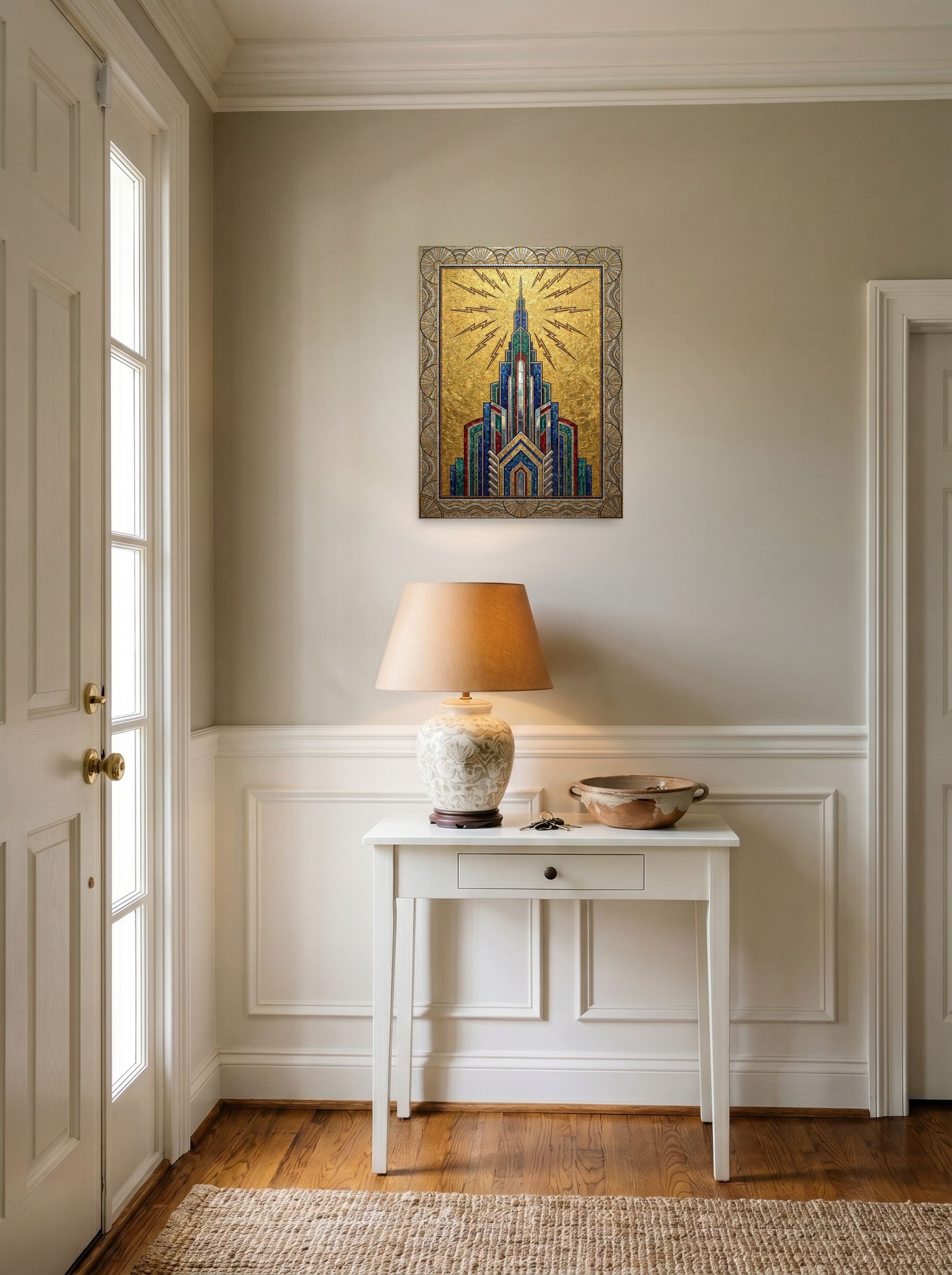 A 18x24 inch unframed paper Art Deco print of 'The Golden Metropolis' hanging in an entryway near a console.