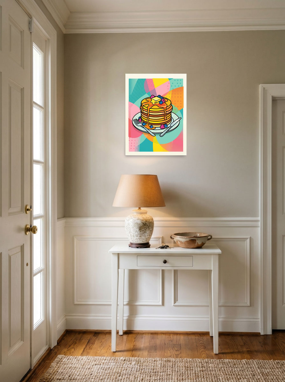 A 18x24 inch unframed paper Pop art print of 'Pop Pancakes' hanging in an entryway near a console.