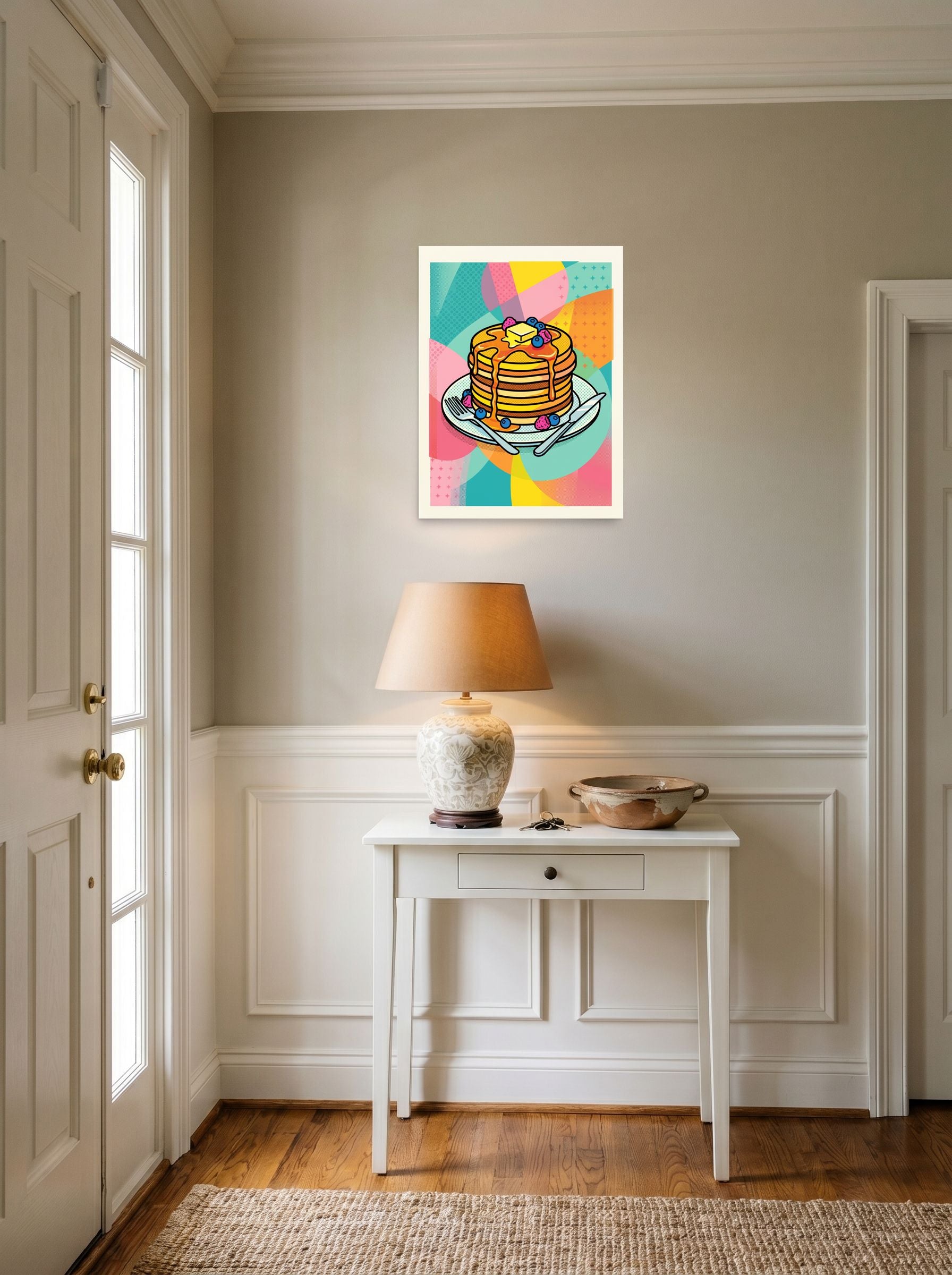 A 18x24 inch unframed paper Pop art print of 'Pop Pancakes' hanging in an entryway near a console.