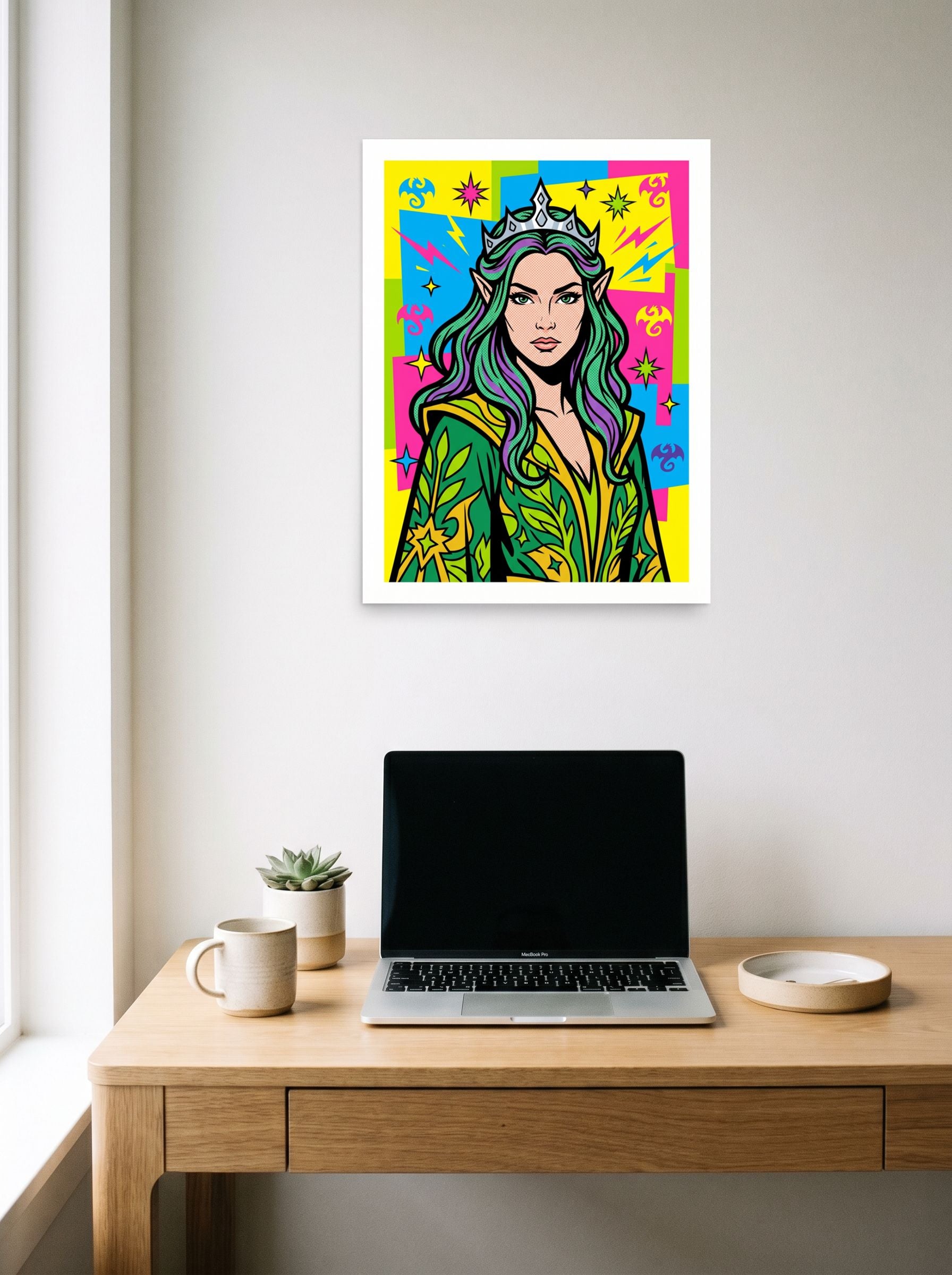 A 18x24 inch unframed paper Pop art print of 'Elven Queen of Pop' hanging above a worktable with a laptop.