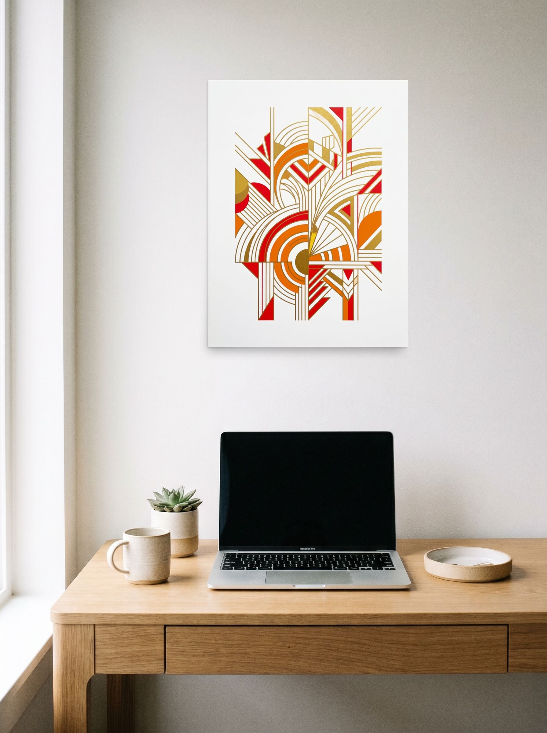 A 18x24 inch unframed paper Art Deco print of 'Radiant Deco Abstract' hanging above a worktable with a laptop.