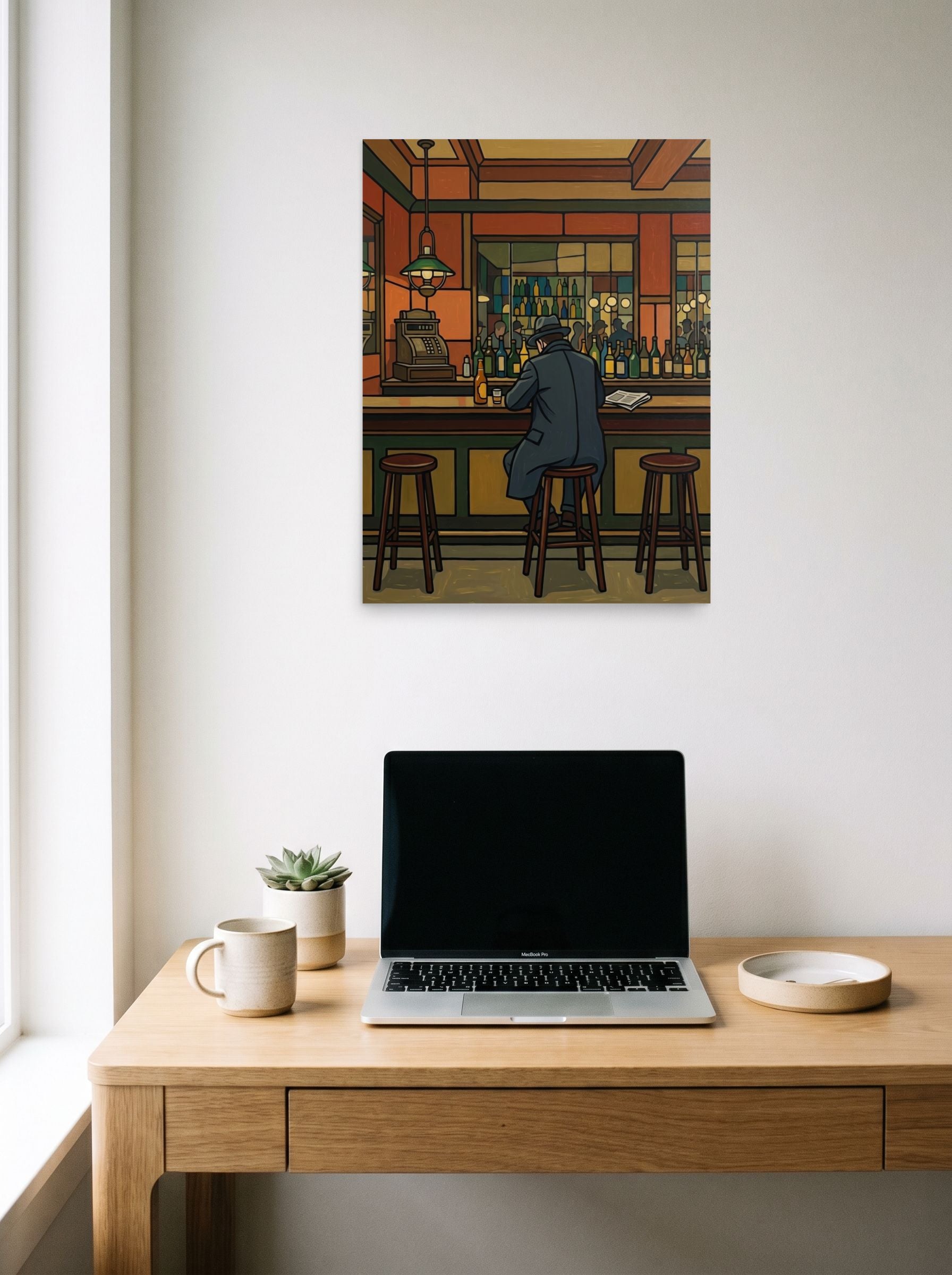 A 18x24 inch unframed paper Cloisonnism print of 'Solitude at the Bar' hanging above a worktable with a laptop.