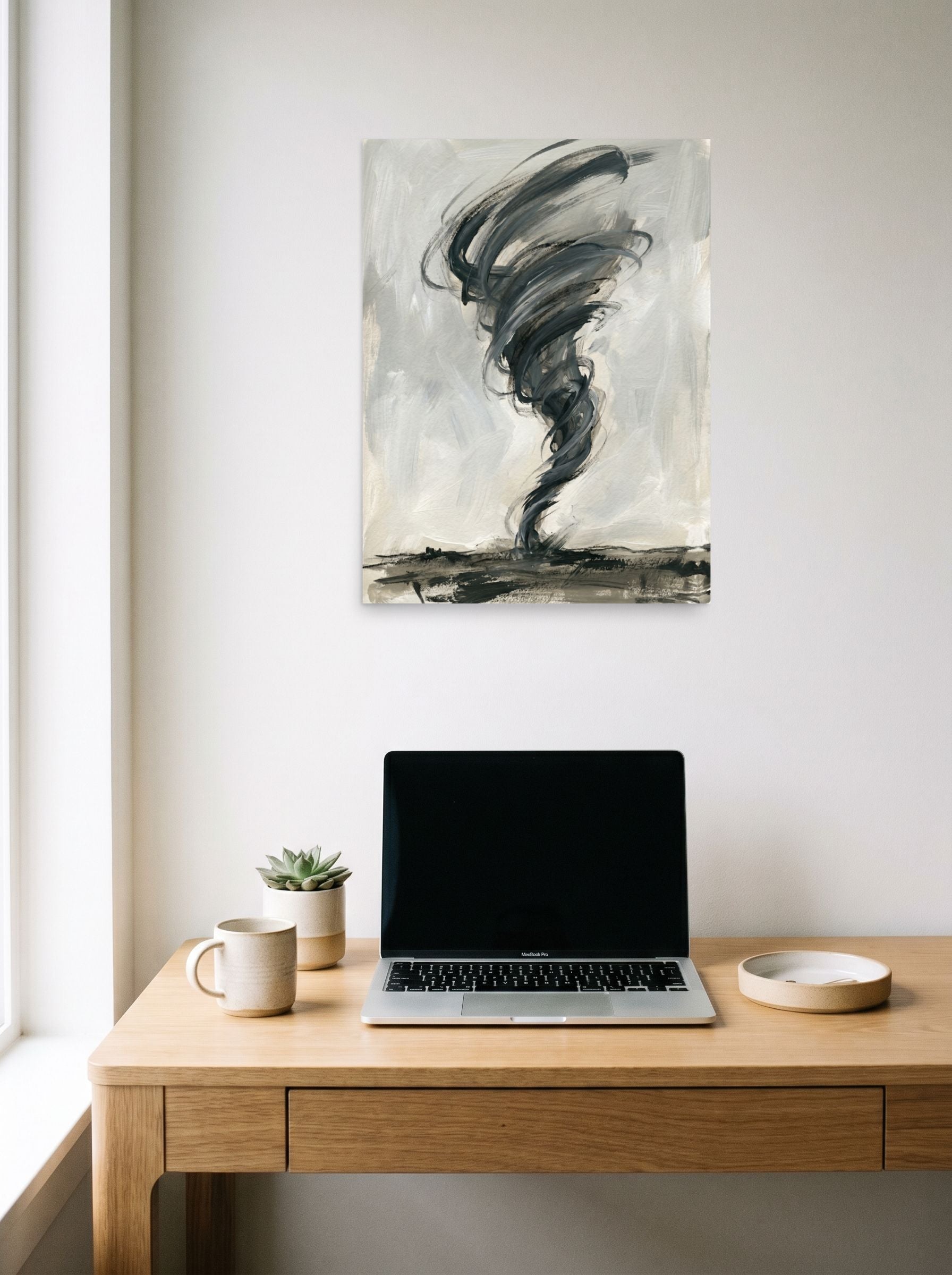 A 18x24 inch unframed paper Abstract expressionism,Minimalism print of 'Abstract Tempest' hanging above a worktable with a laptop.