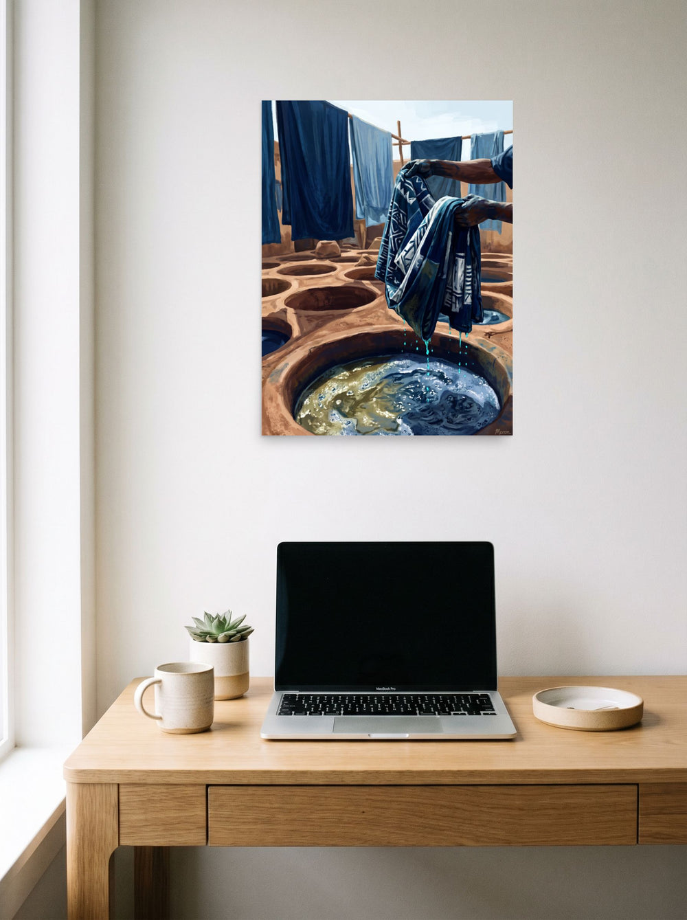 'The Indigo Dyer' in 18x24 inch unframed paper, hanging above a worktable with a laptop.