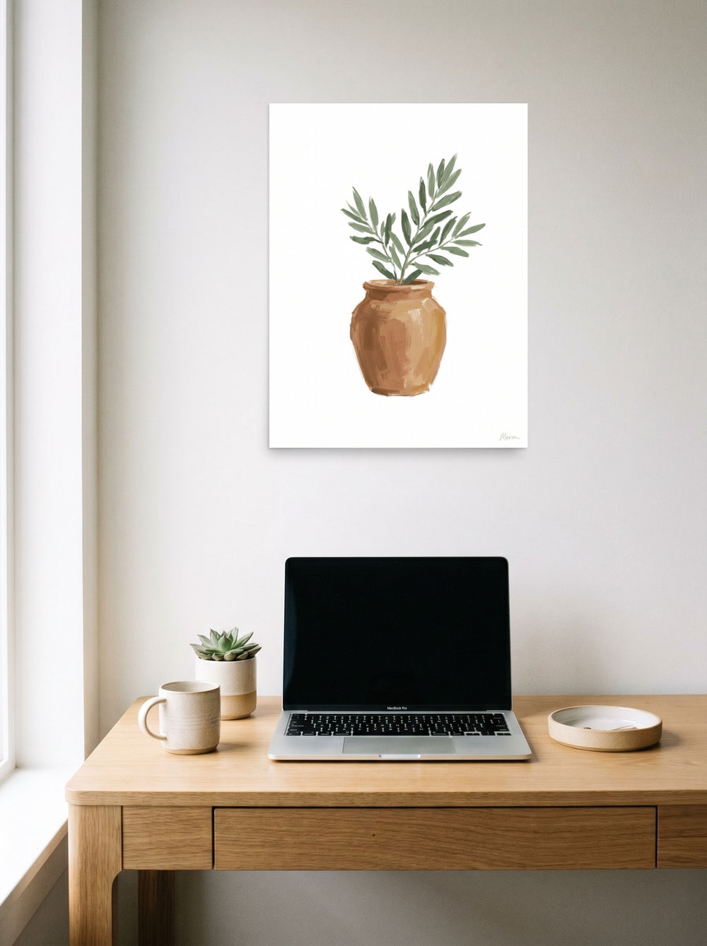 A 18x24 inch unframed paper Minimalism,Modernism print of 'Olive in Terracotta' hanging above a worktable with a laptop.