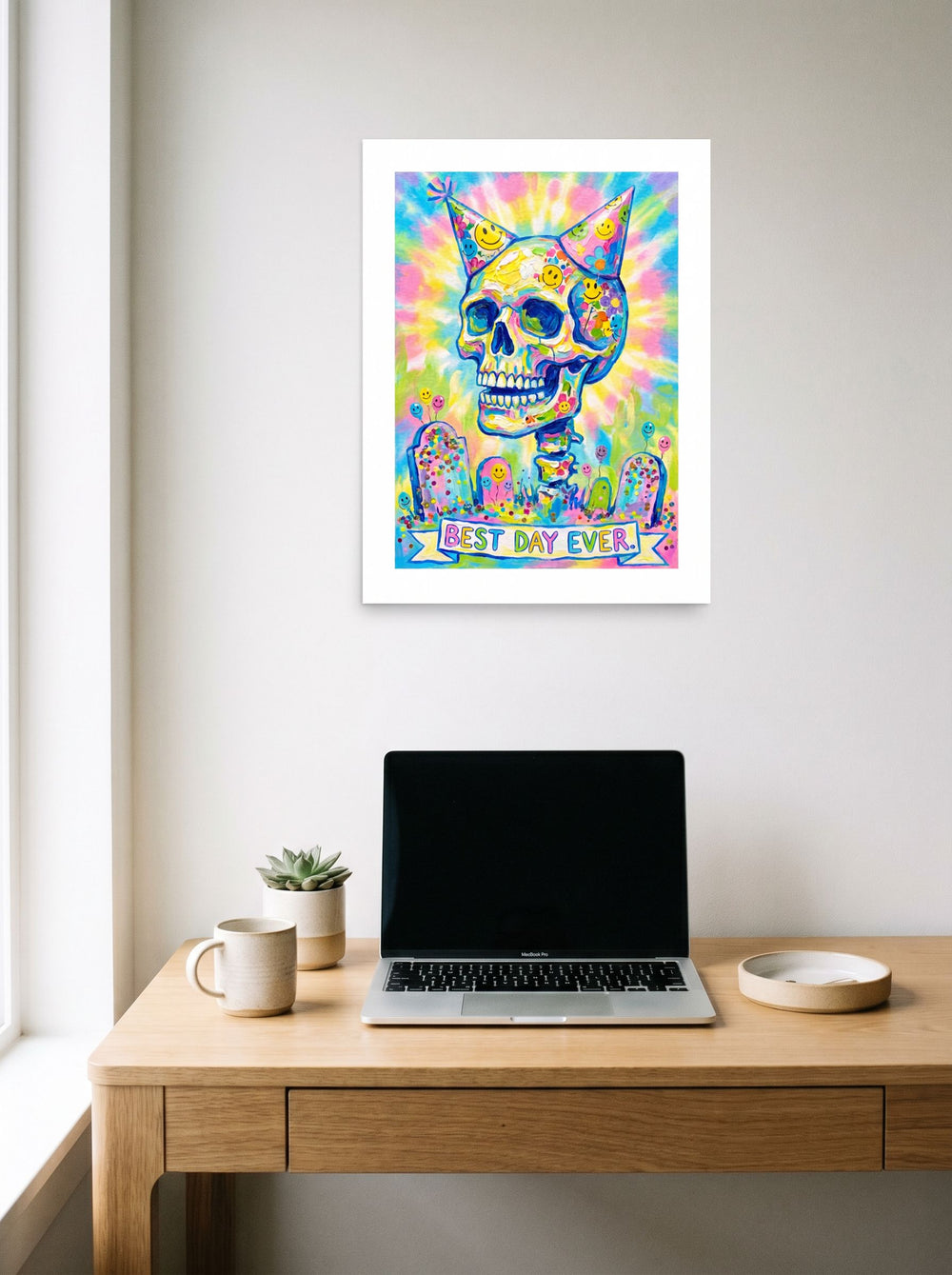 The unframed paper print 'Best Day Ever' hanging above a worktable with a laptop, shown at 18x24 inch.