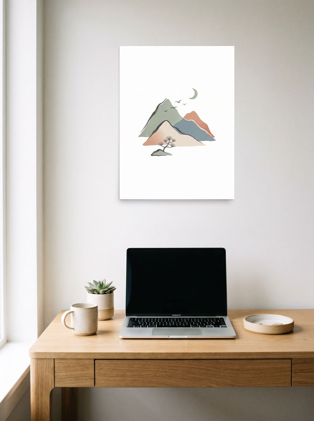 A 18x24 inch unframed paper Shin hanga print of 'Mountain Solace' hanging above a worktable with a laptop.