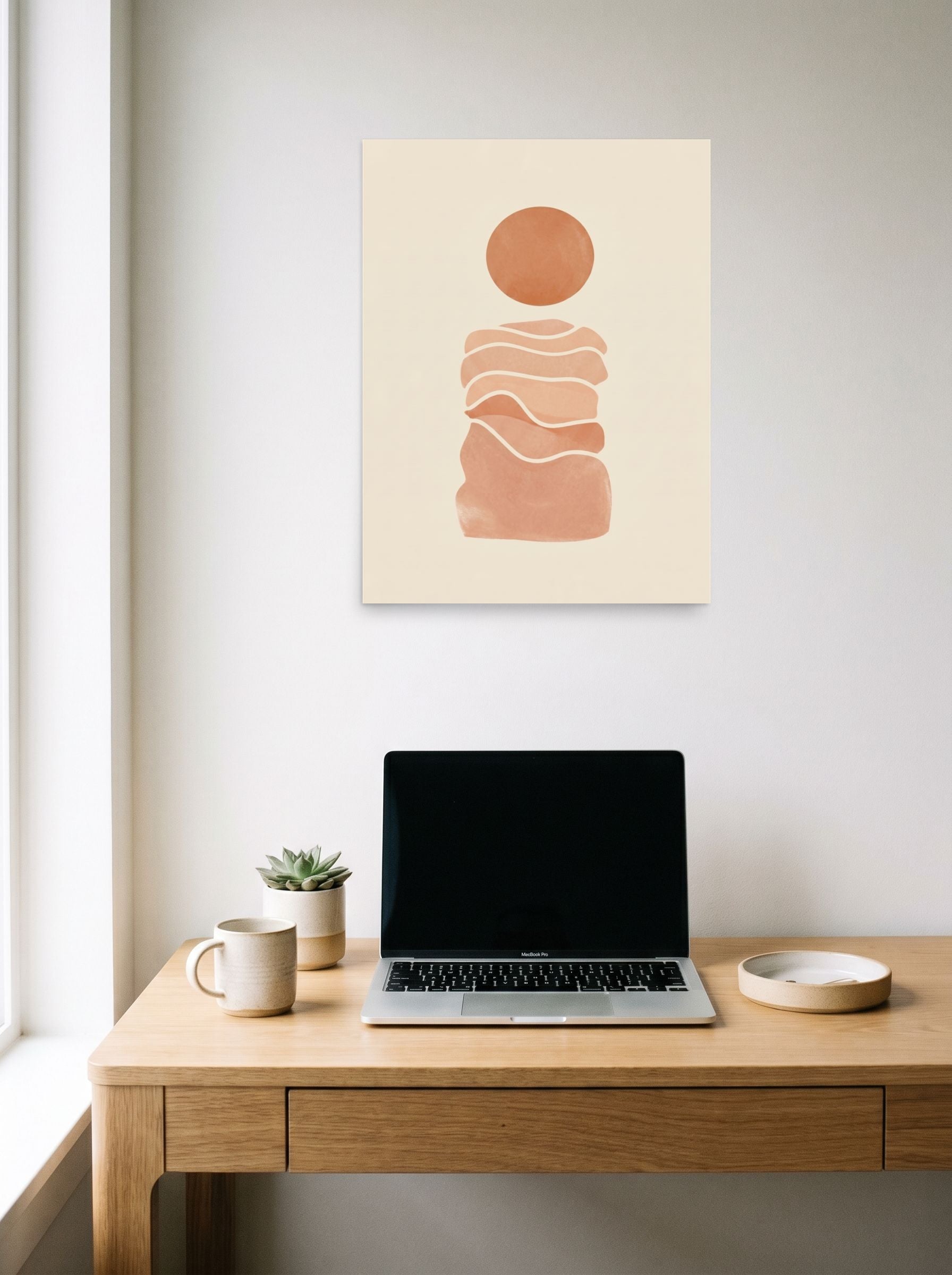 A 18x24 inch unframed paper Minimalism print of 'Desert Sun Reverie' hanging above a worktable with a laptop.