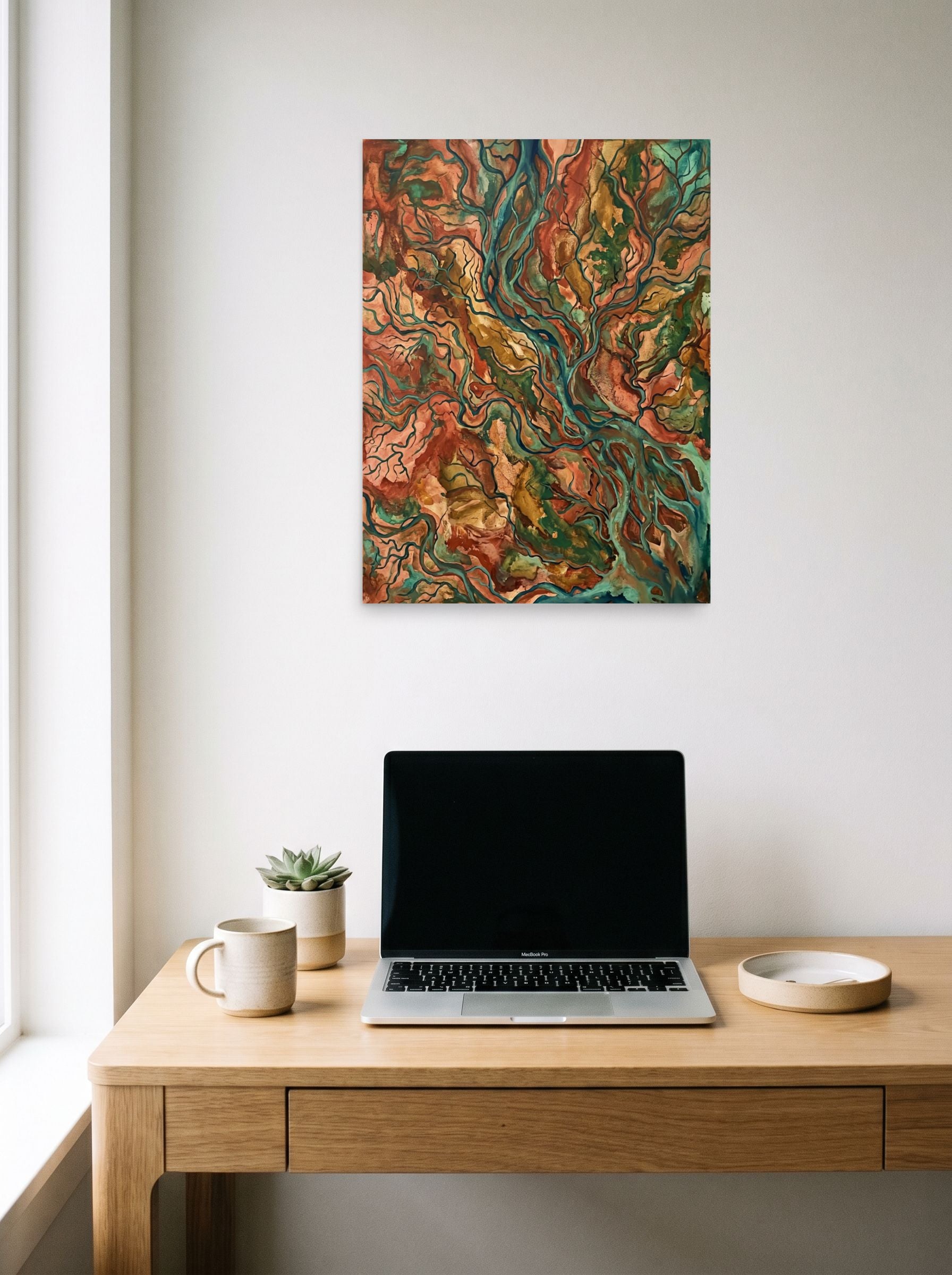 A 18x24 inch unframed paper Abstract expressionism,Abstract art print of 'Earth Veins' hanging above a worktable with a laptop.