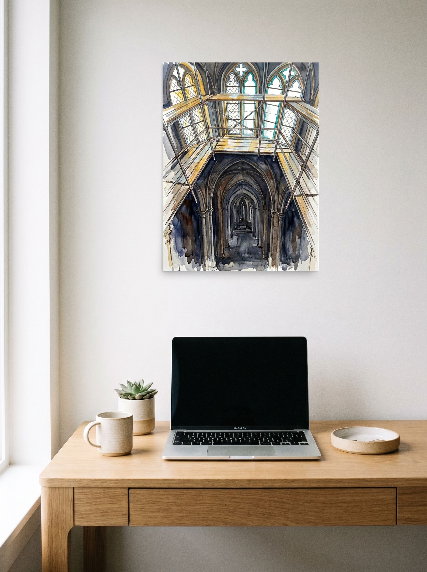 A 18x24 inch unframed paper Abstract expressionism print of 'Baltic Sea Ice Breaking' hanging above a worktable with a laptop.